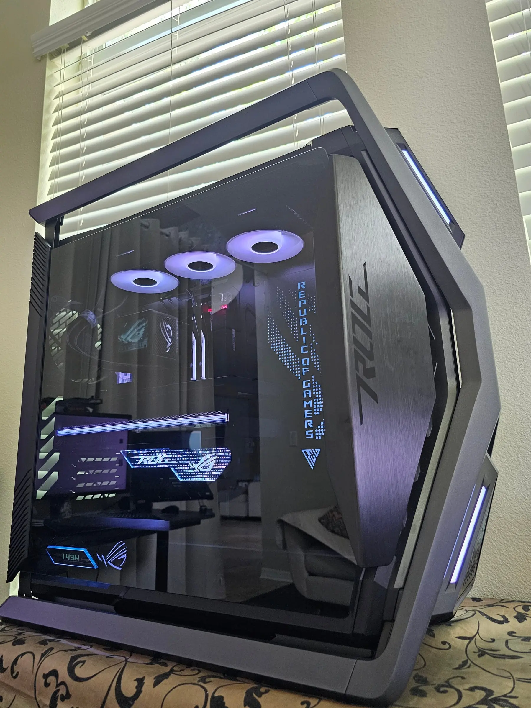 ROG Hyperion GR701 in ice-white lighting — dot-matrix Republic of Gamers glass, Thor power readout, and brushed ROG side armor