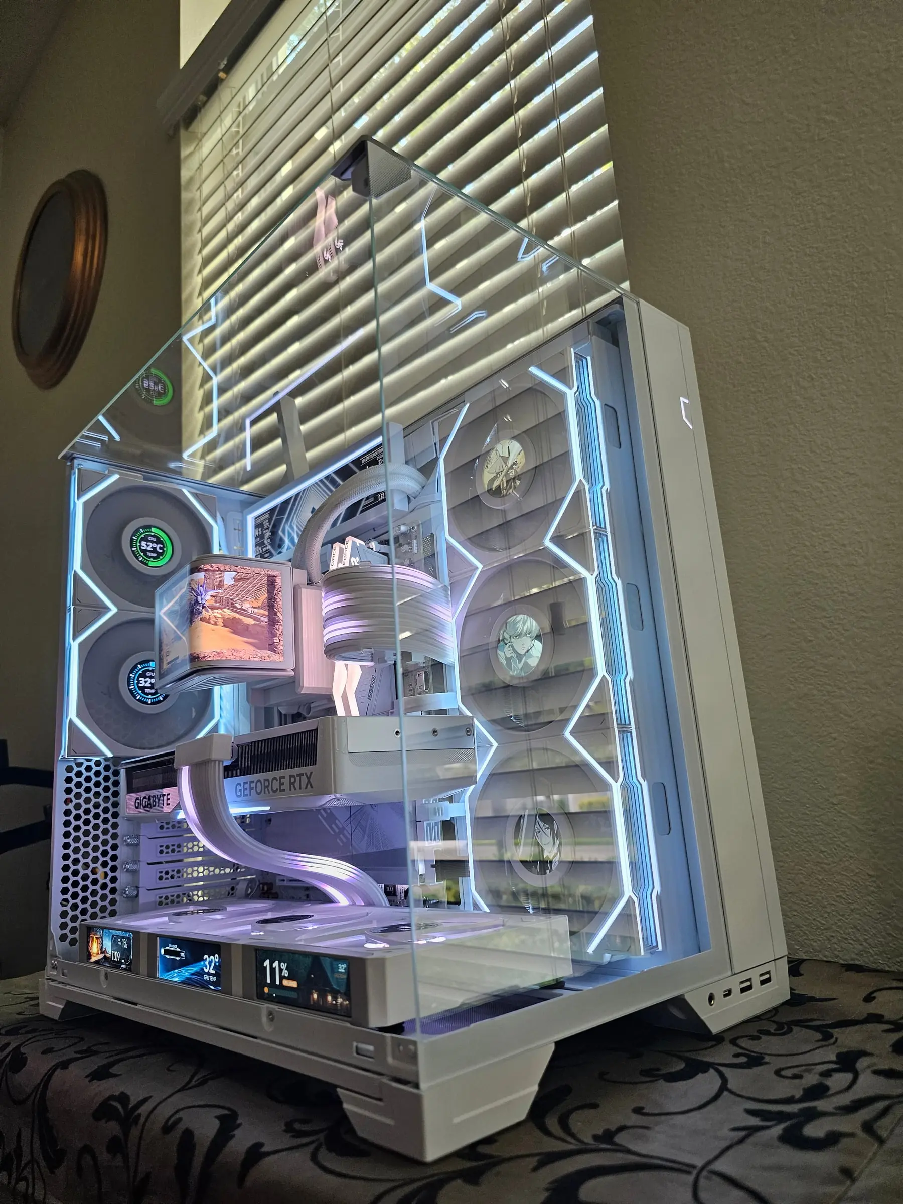 White-violet three-quarter with the Hydroshift OLED playing a game clip and temp dials on the fan hubs