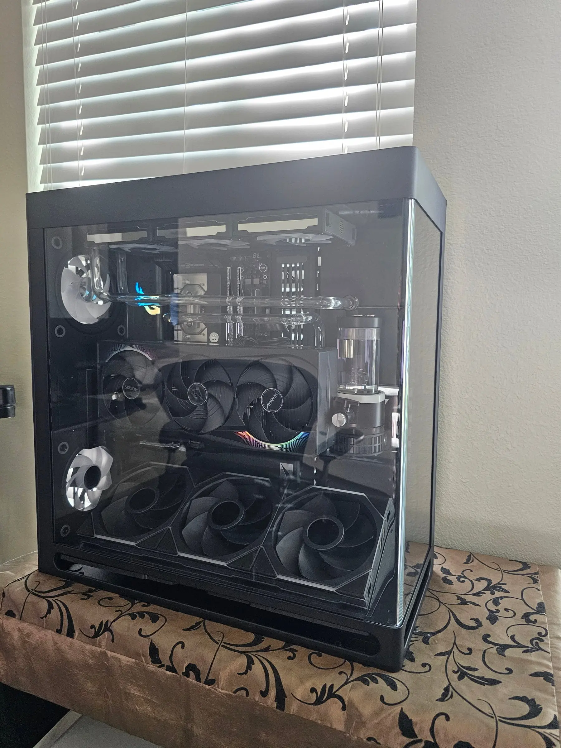 Unpowered daylight view of the hardline acrylic runs, EK block, reservoir tower, and Aorus Master RTX 5090