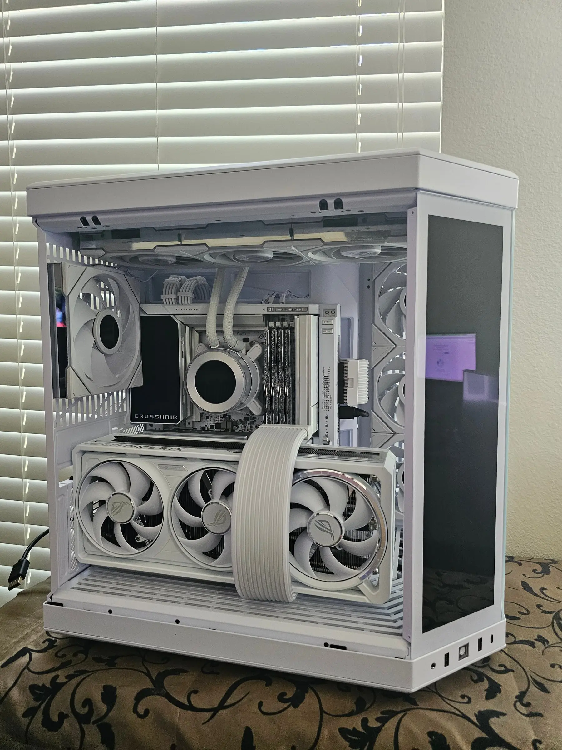 Full white build unpowered — ROG Crosshair X870E Glacial, RTX 5090 Astral White, and Strimer riser cable in the Hyte Y70 Touch