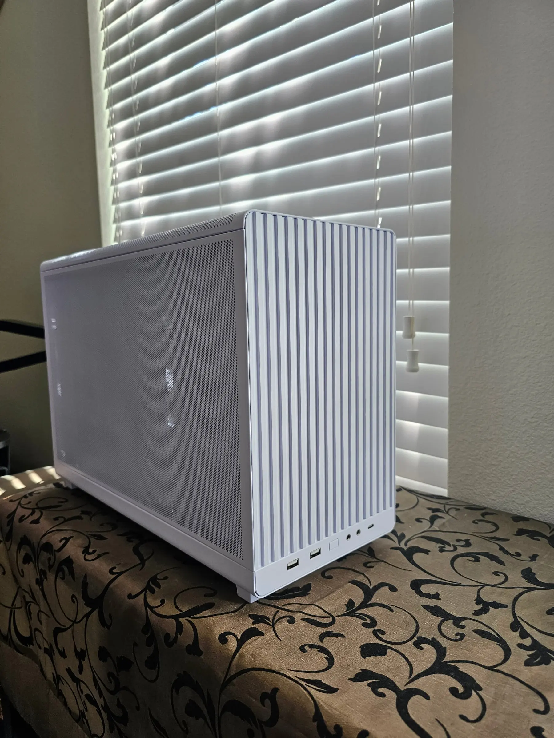Lian Li A3 White three-quarter view showing the ridged top panel and mesh front