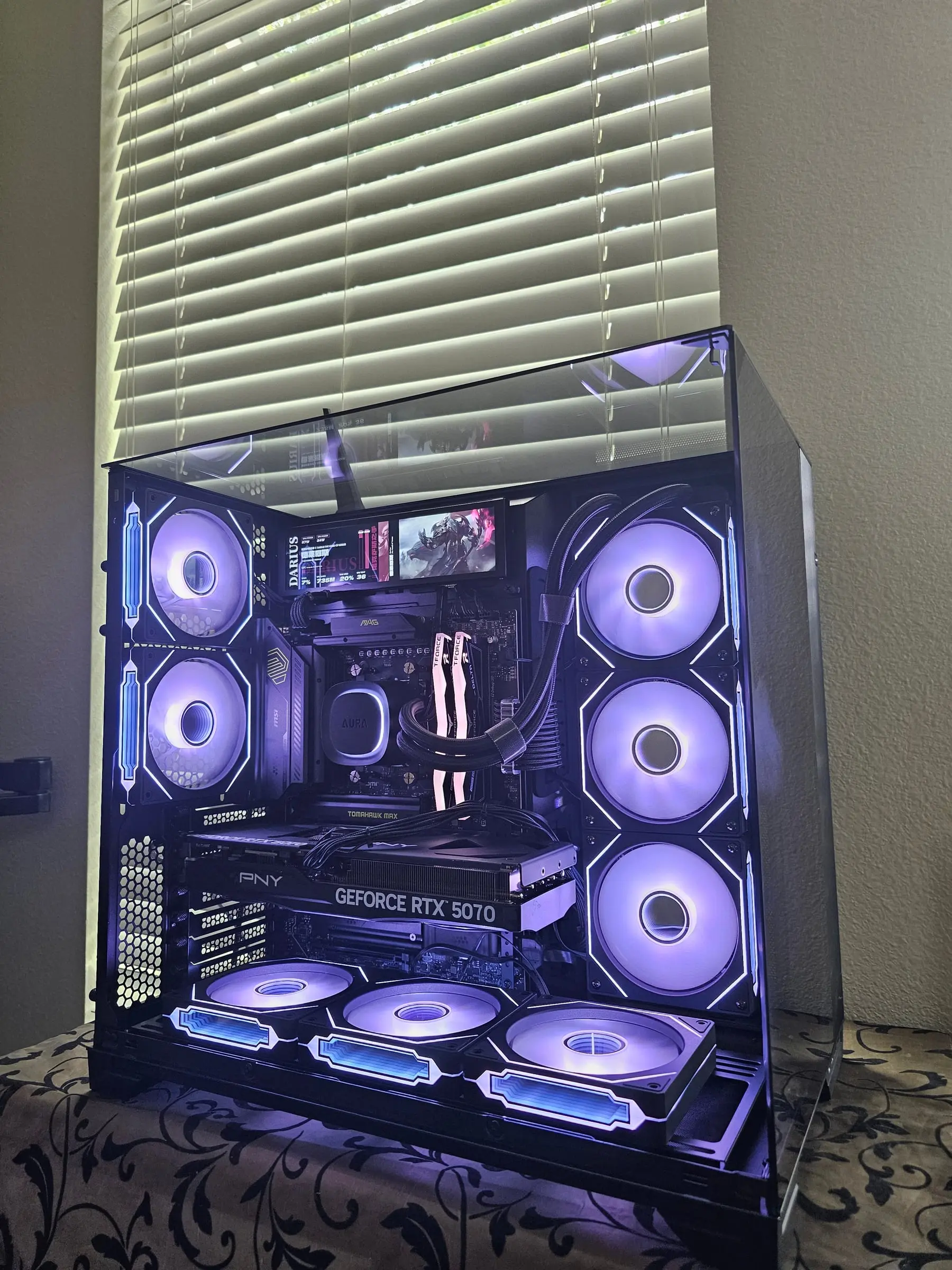 Front view with the sensor panel running a League of Legends stat layout above the MAG B850 board
