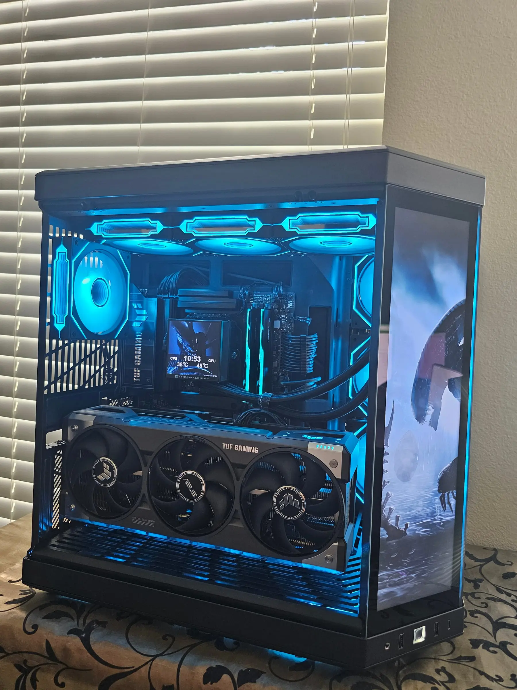 Interior in blue — TUF RTX 5090, Hyper Vision LCD showing live temps, and sleeved cables in the Y70