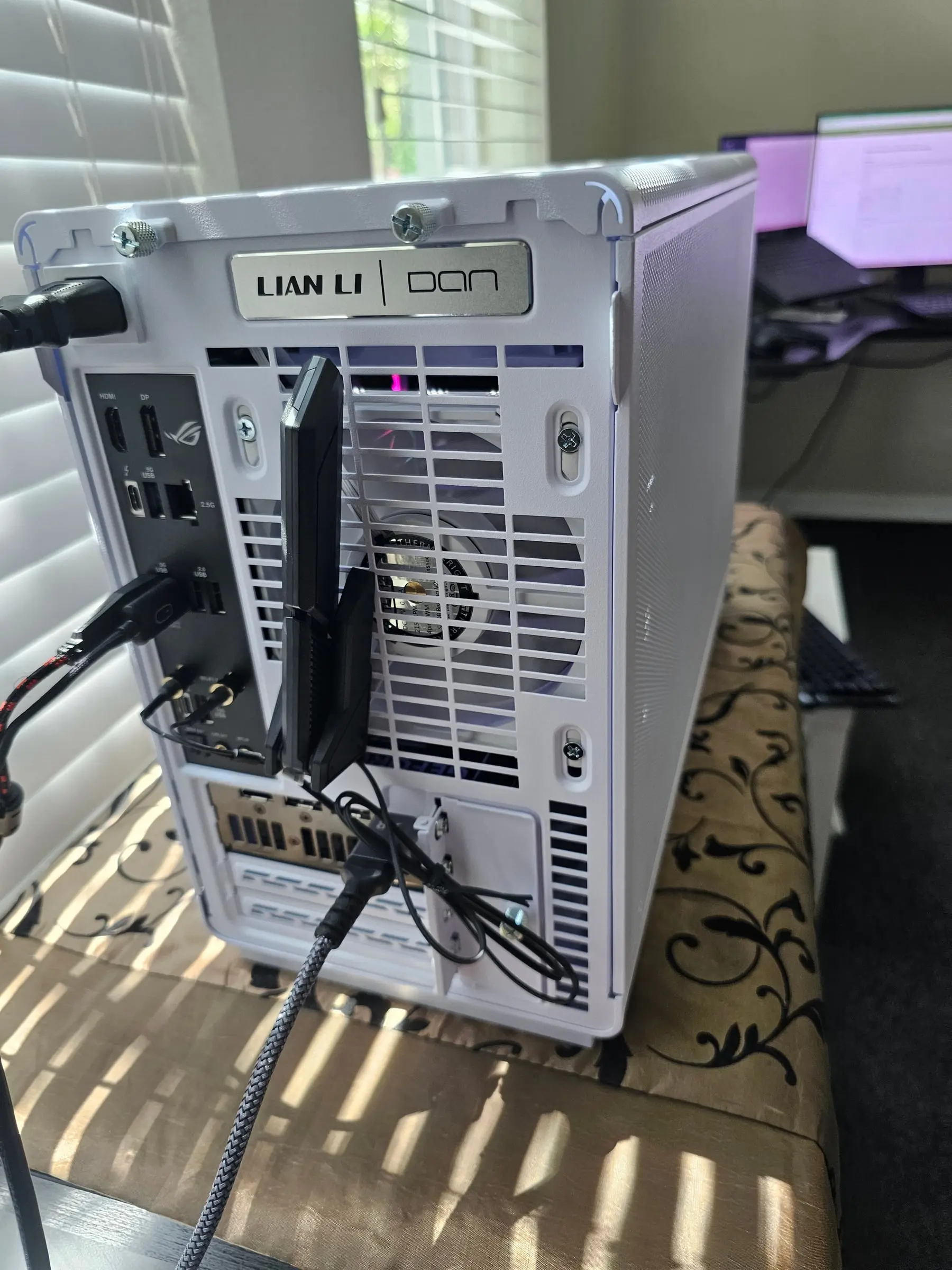 Rear of the Lian Li A3 with ROG Strix rear I/O, Wi-Fi antennas, and white exhaust fan