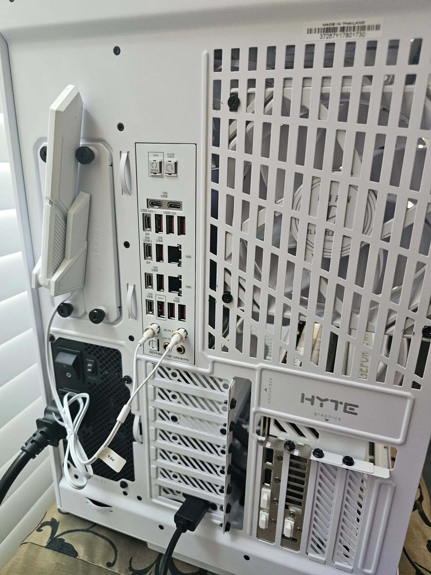Rear I/O of the Crosshair X870E Glacial — Wi-Fi 7 antennas, stacked USB, dual LAN — with the 1600W PSU below