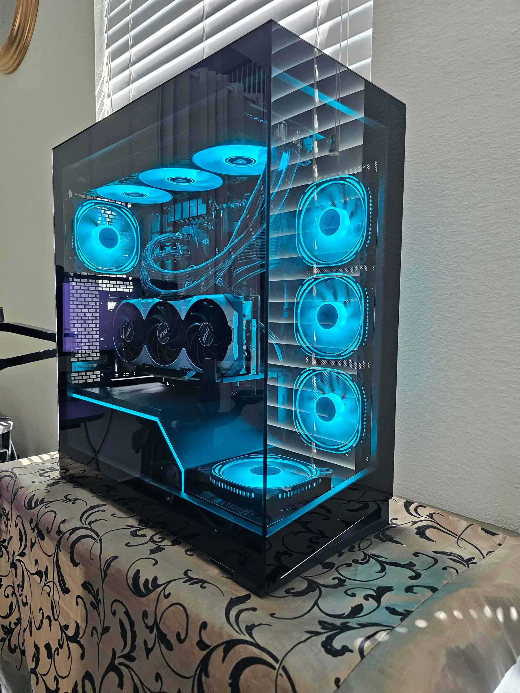 Teal theme — Prism fans and the PSU shroud light strip tracing the NV5's interior shelf