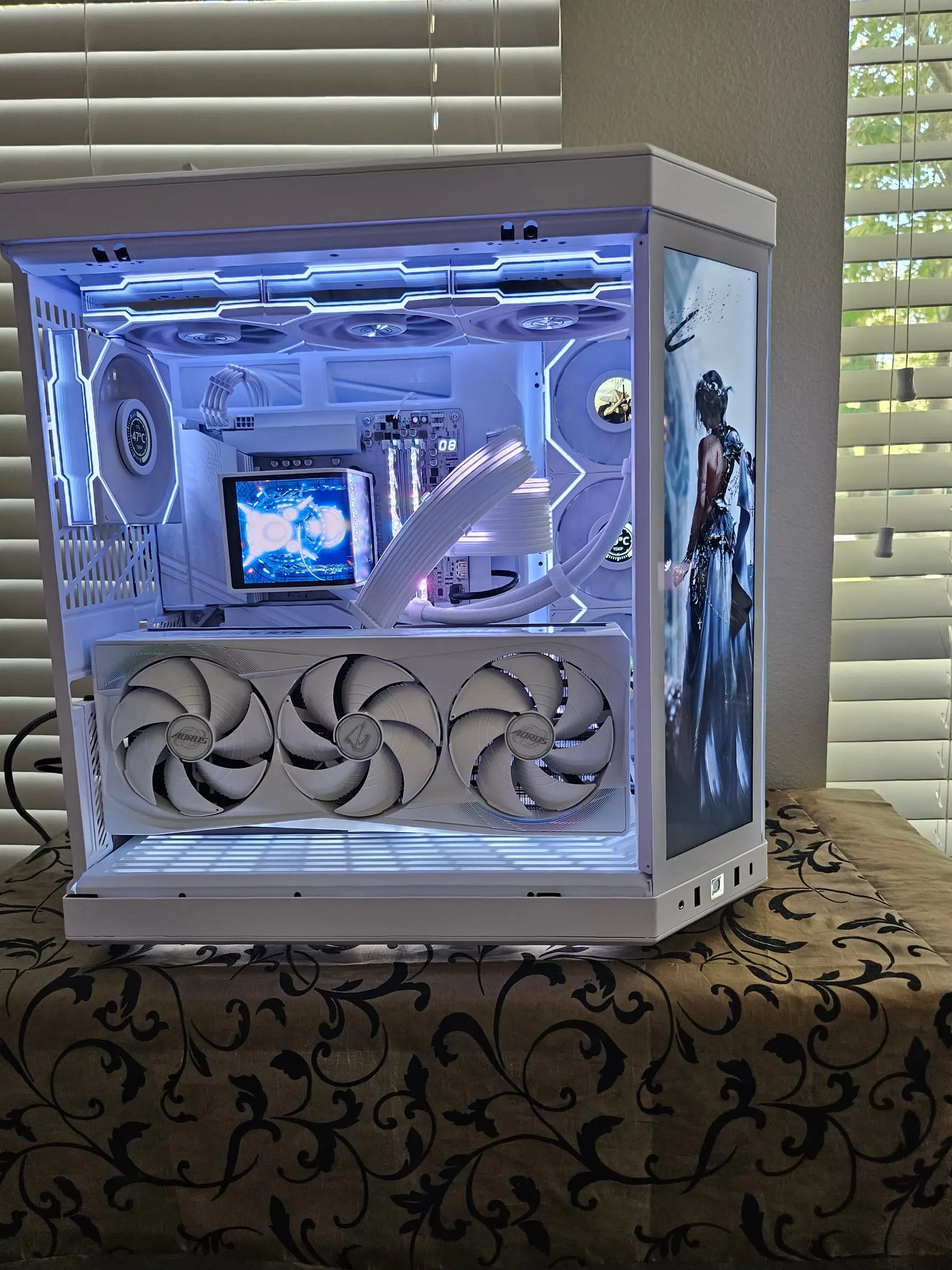 Full interior view — AORUS RTX 5080 Master Ice fans, RGB memory, the TRYX AIO pump's own display, and the touchscreen panel glowing blue