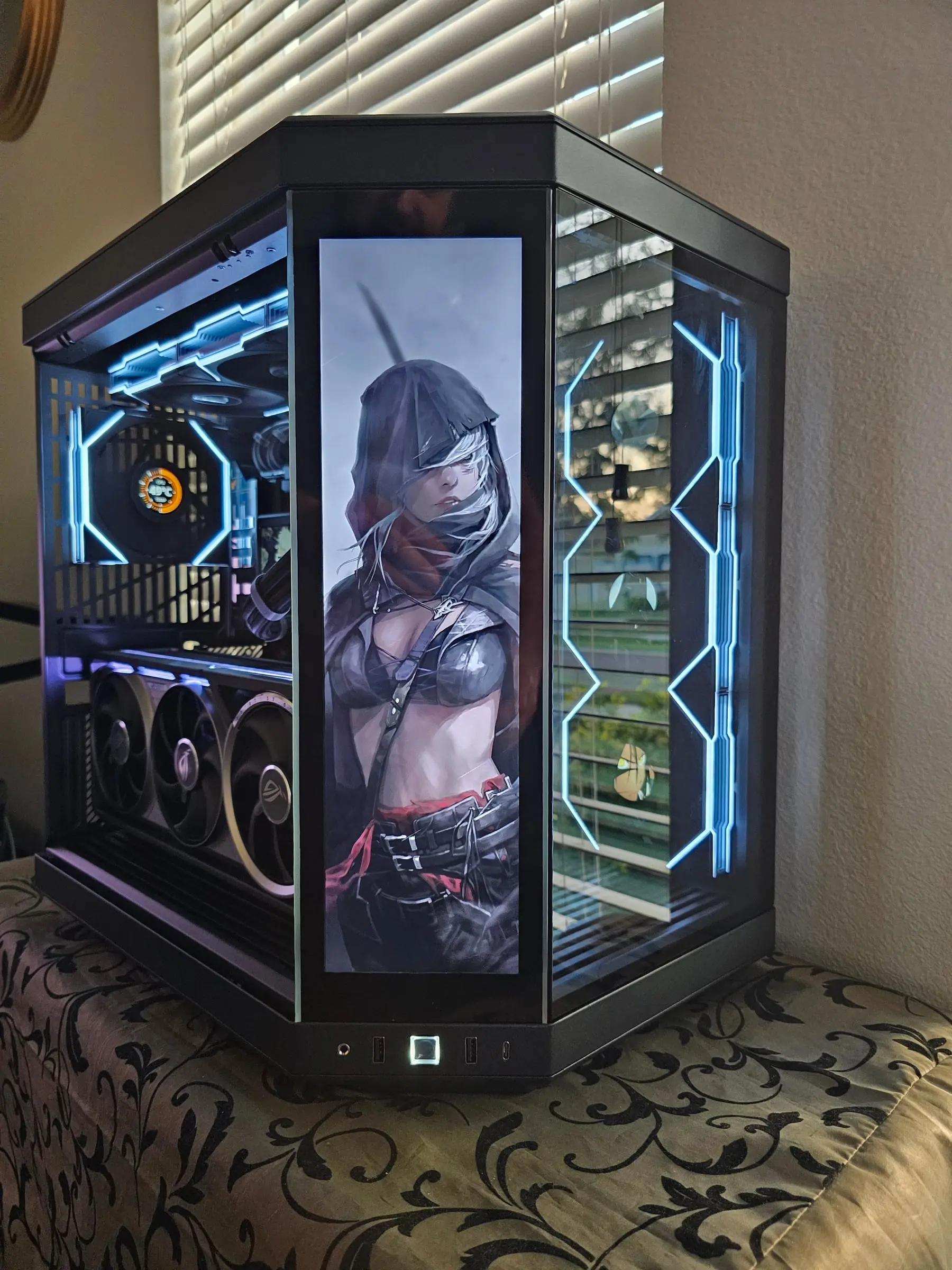Hooded rogue artwork across the front touchscreen in white-blue lighting