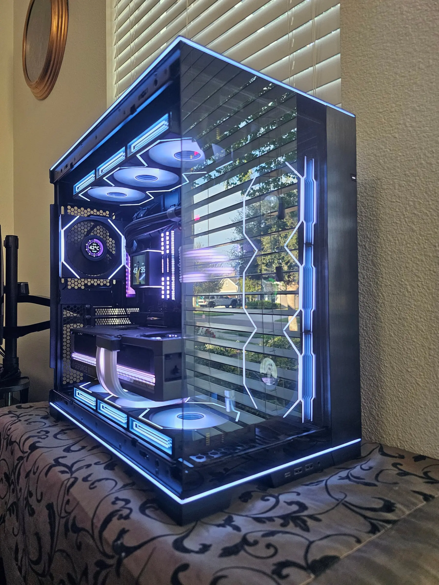 Rear-quarter view of the frame edge lighting tracing every line of the EVO RGB in blue