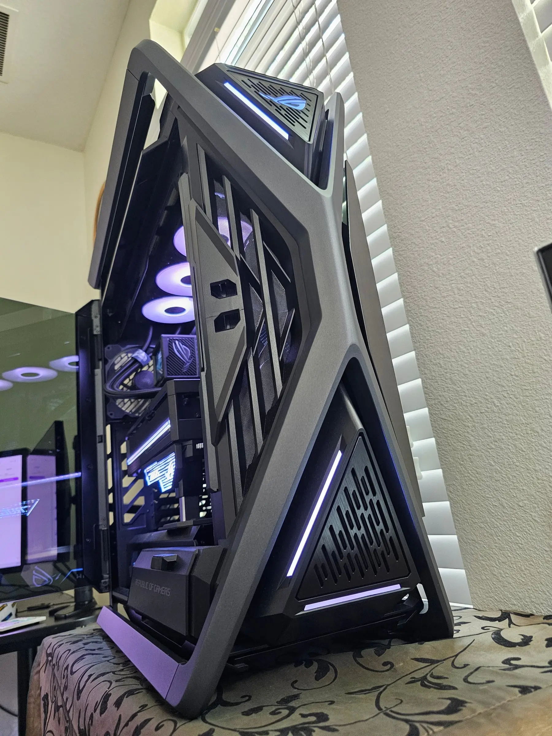 Angular side profile of the GR701 with the hinged glass door open and white fans glowing