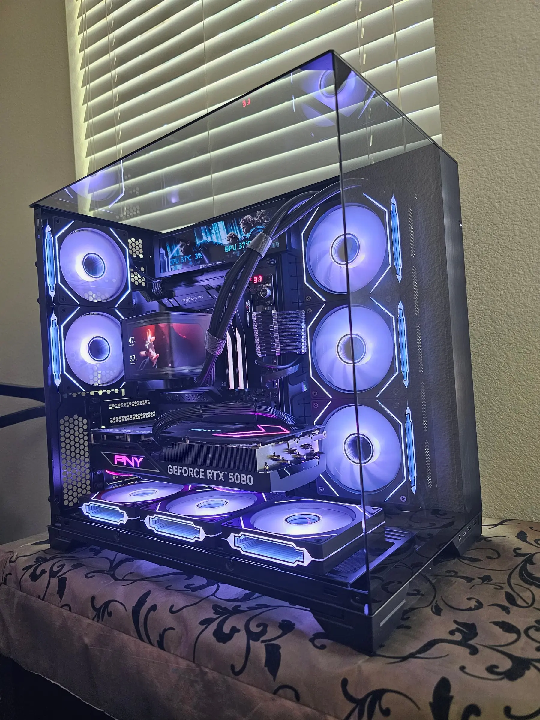 Both in-case displays running artwork while eight Prism 4RS fans glow white-violet