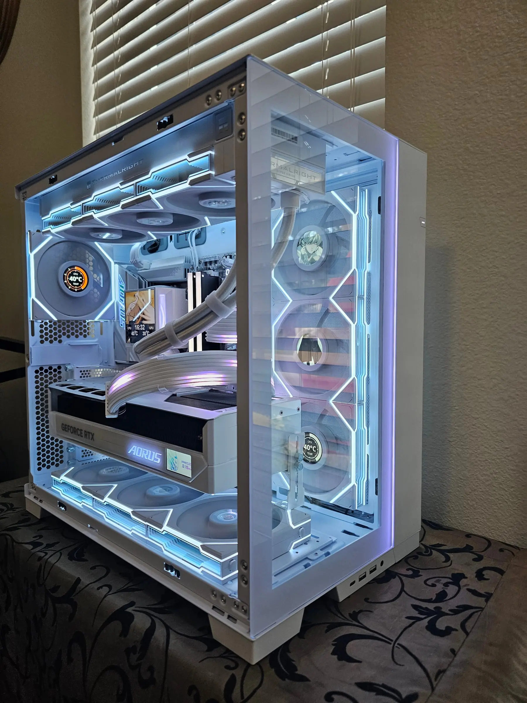 Side view with anime portraits on the TL LCD fans and the Master Ice's AORUS badge lit