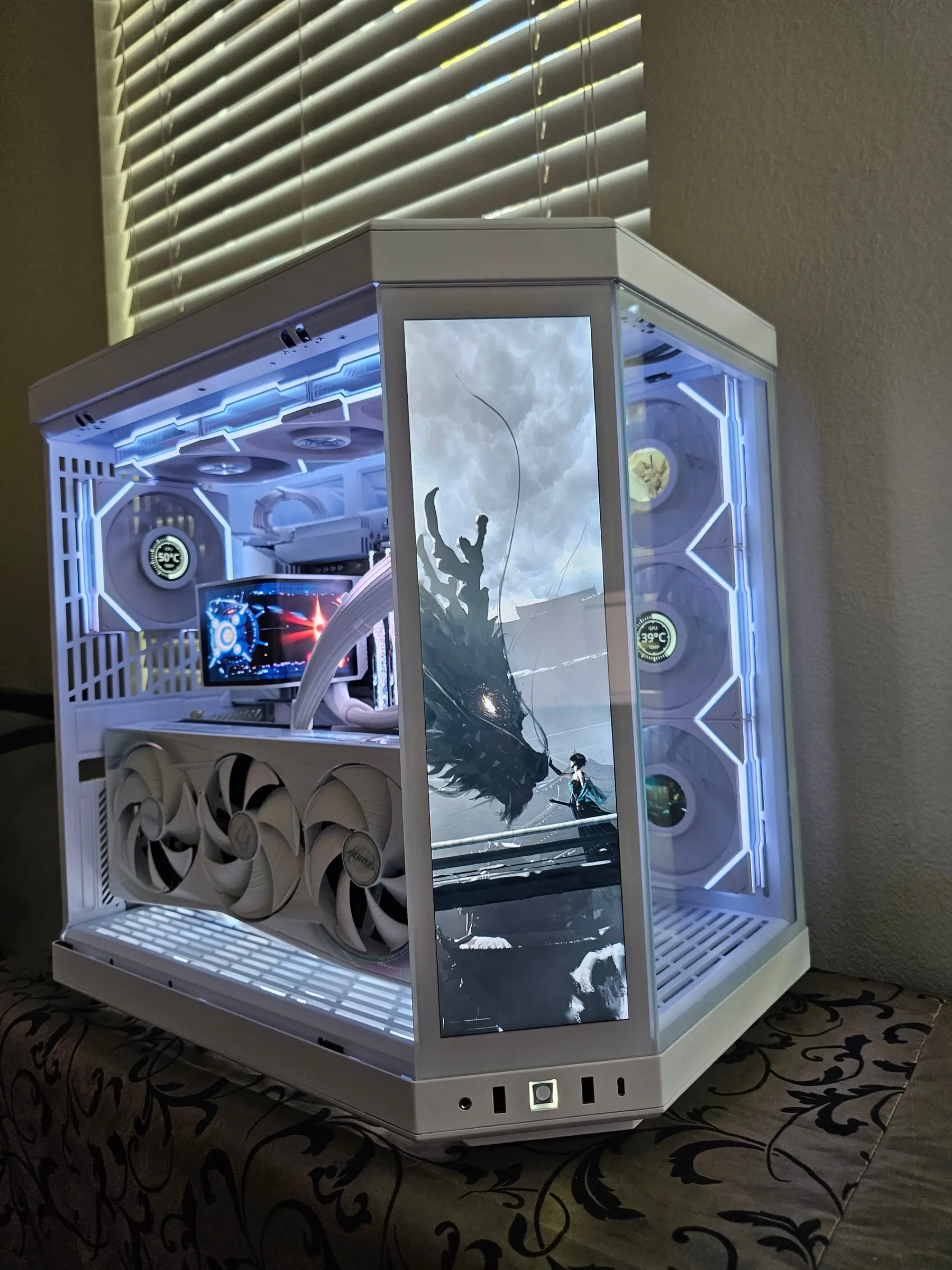 Front-right view with an ink-wash dragon and swordsman scene on the touchscreen, GPU temp reading 39°C on the side fan hub