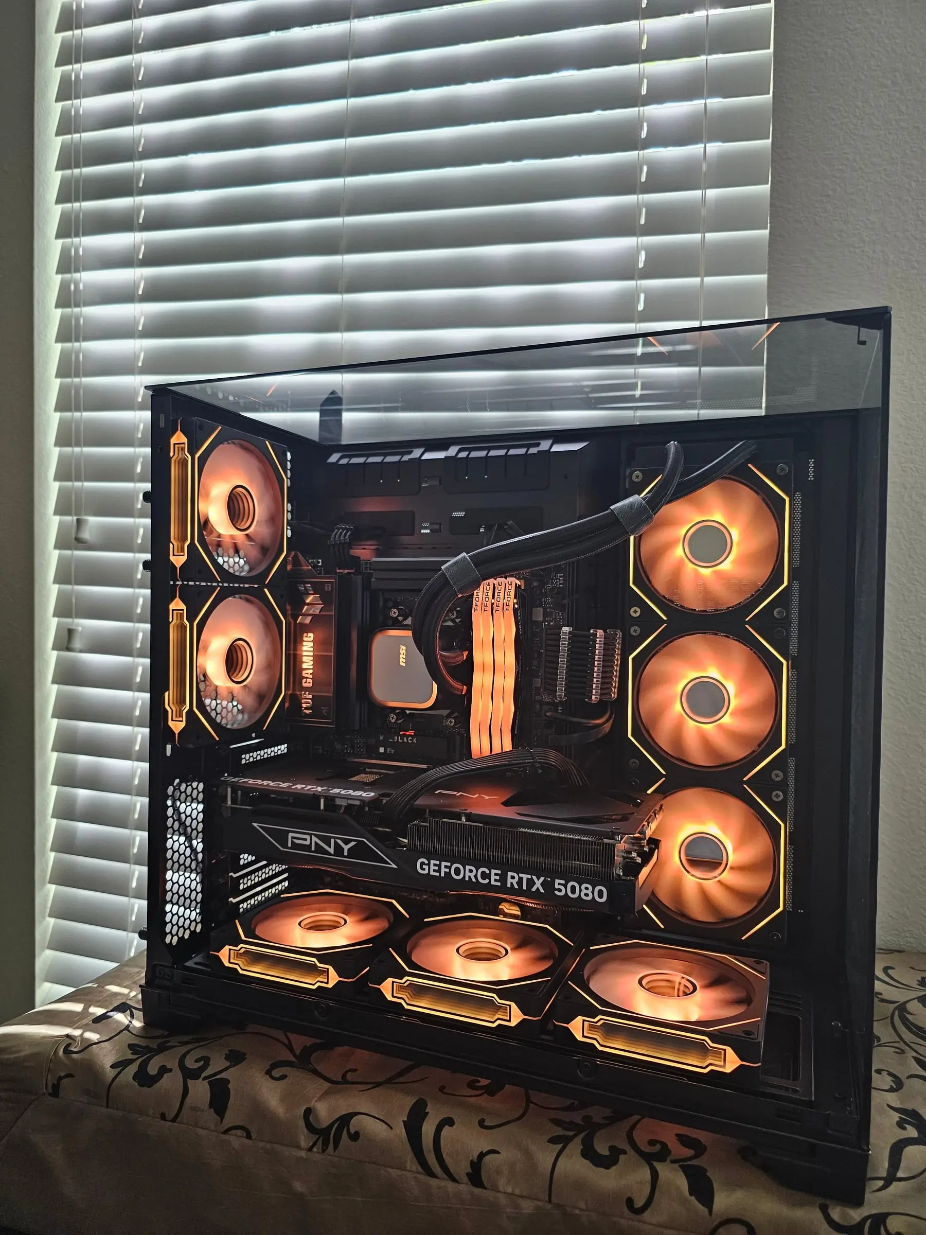 Warm amber theme glowing through the tri-glass corner and hex fan frames