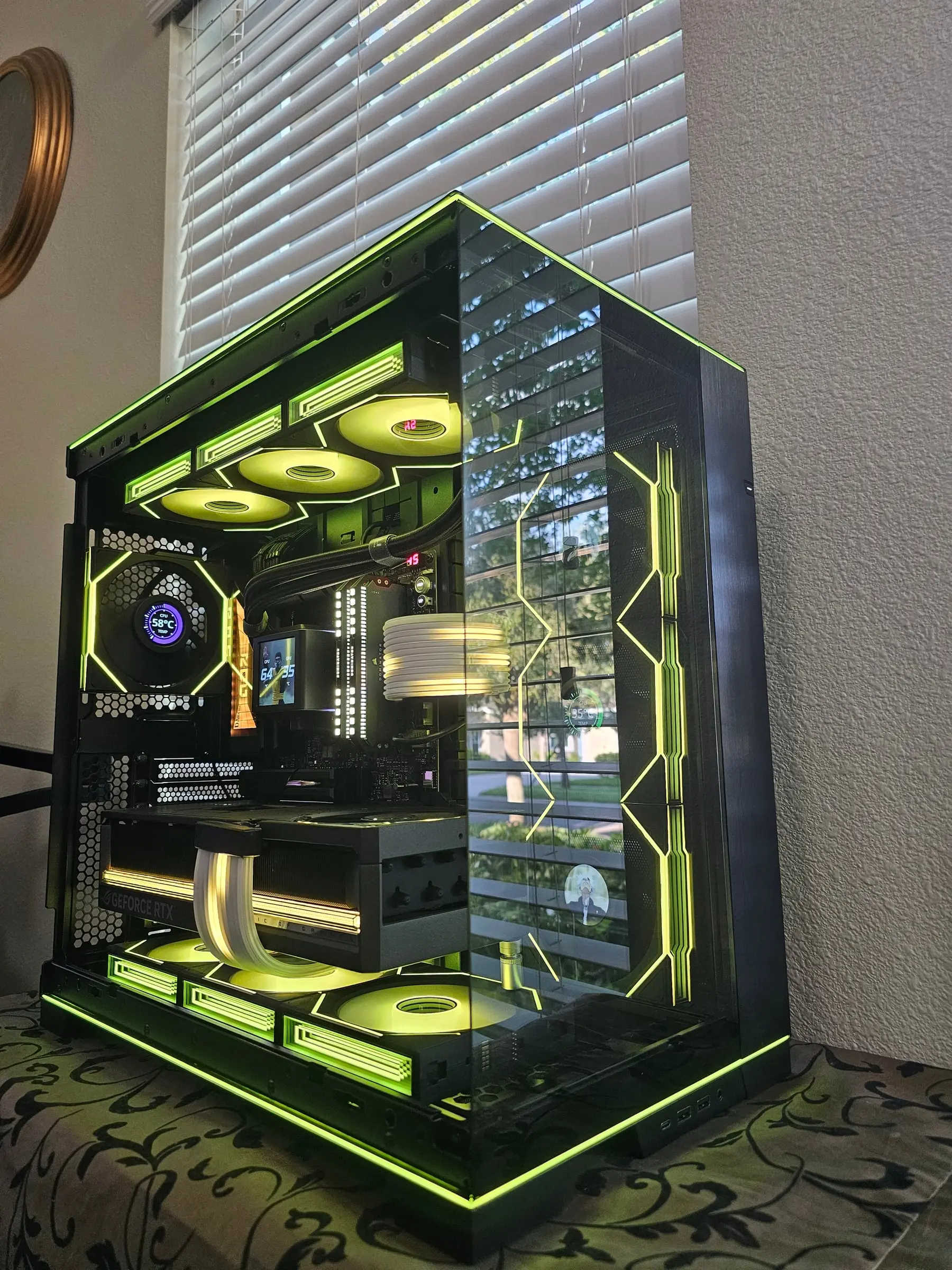 O11 Dynamic EVO RGB in lime green from above — frame strips, infinity fans, and the Astral RTX 5090 with white Strimer cables