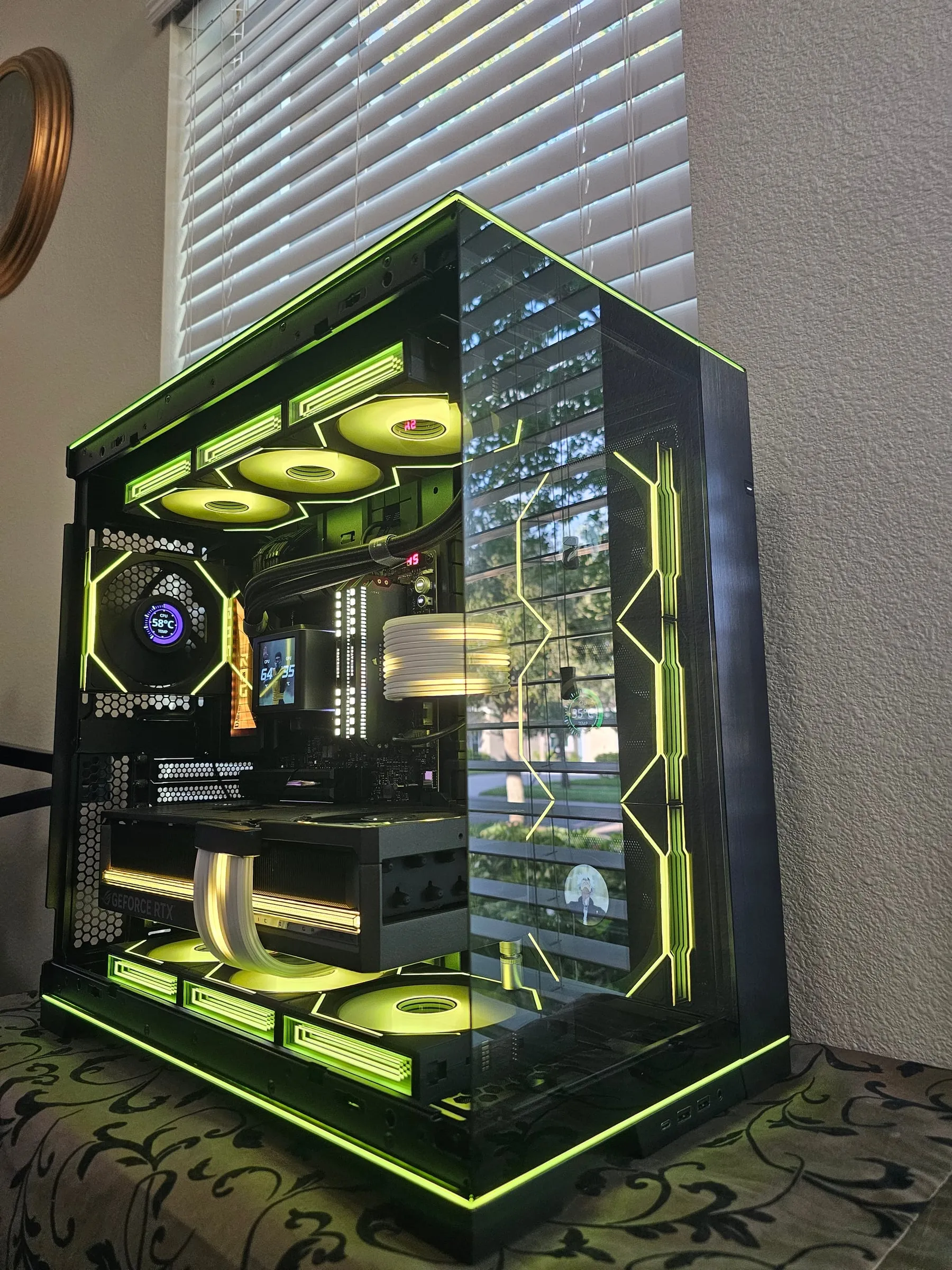 O11 Dynamic EVO RGB in lime green from above — frame strips, infinity fans, and the Astral RTX 5090 with white Strimer cables