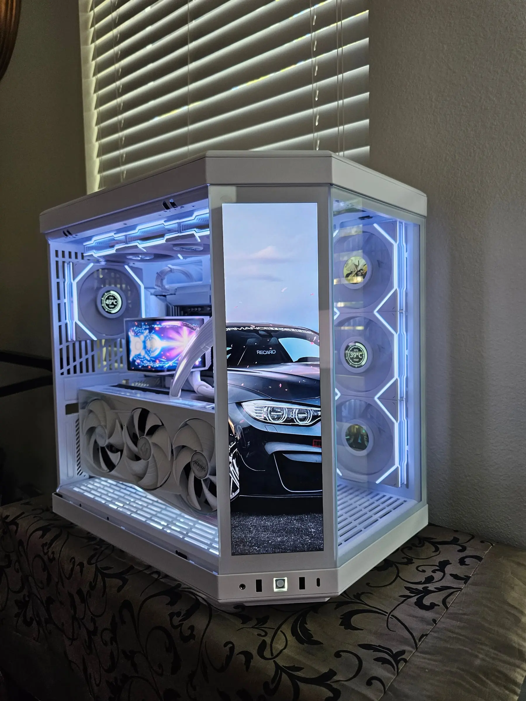 Touchscreen cycled to a black BMW M4 wallpaper, cool blue-white case lighting