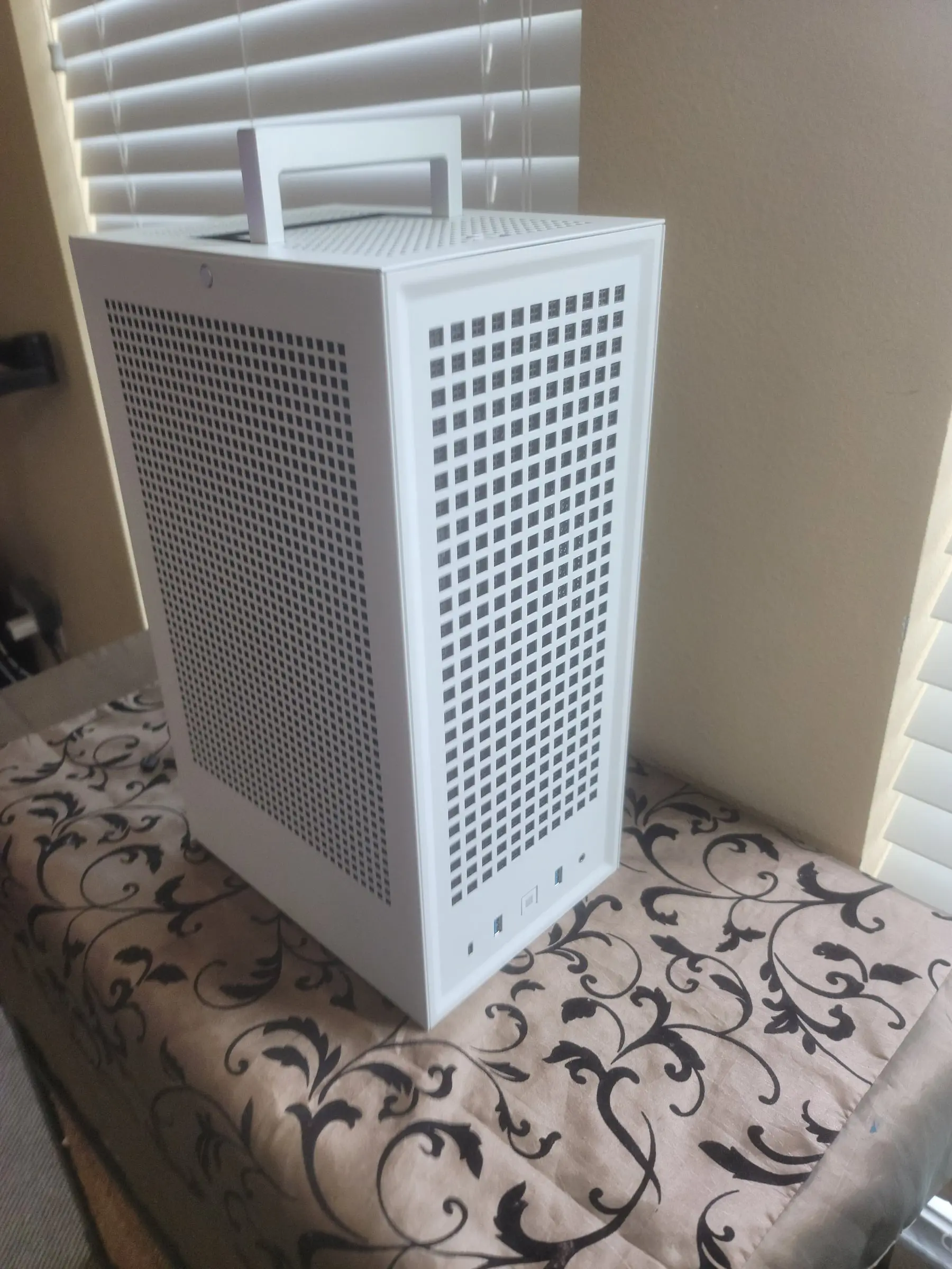 Angled view showing the perforated panels and raised handle against the window light