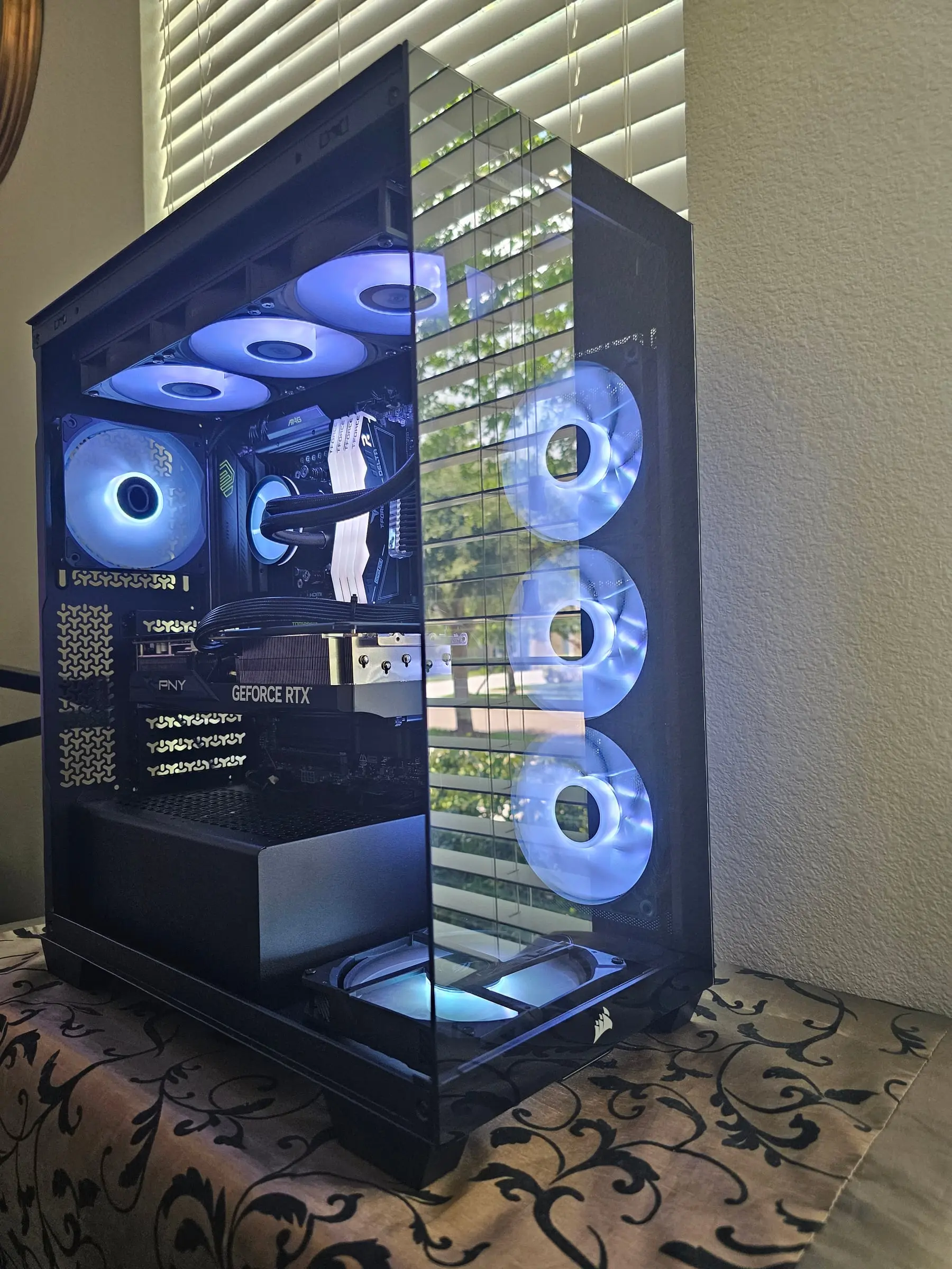 Bright white-blue theme, all eight fans lit around the PNY RTX 5070 Ti
