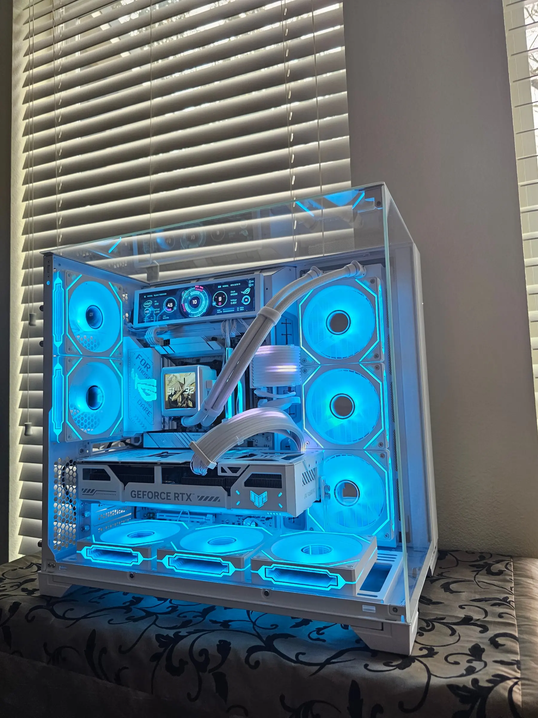 All-white O11 Vision in teal — sensor panel running a full ROG dashboard while the Hyper Vision LCD shows art and temps