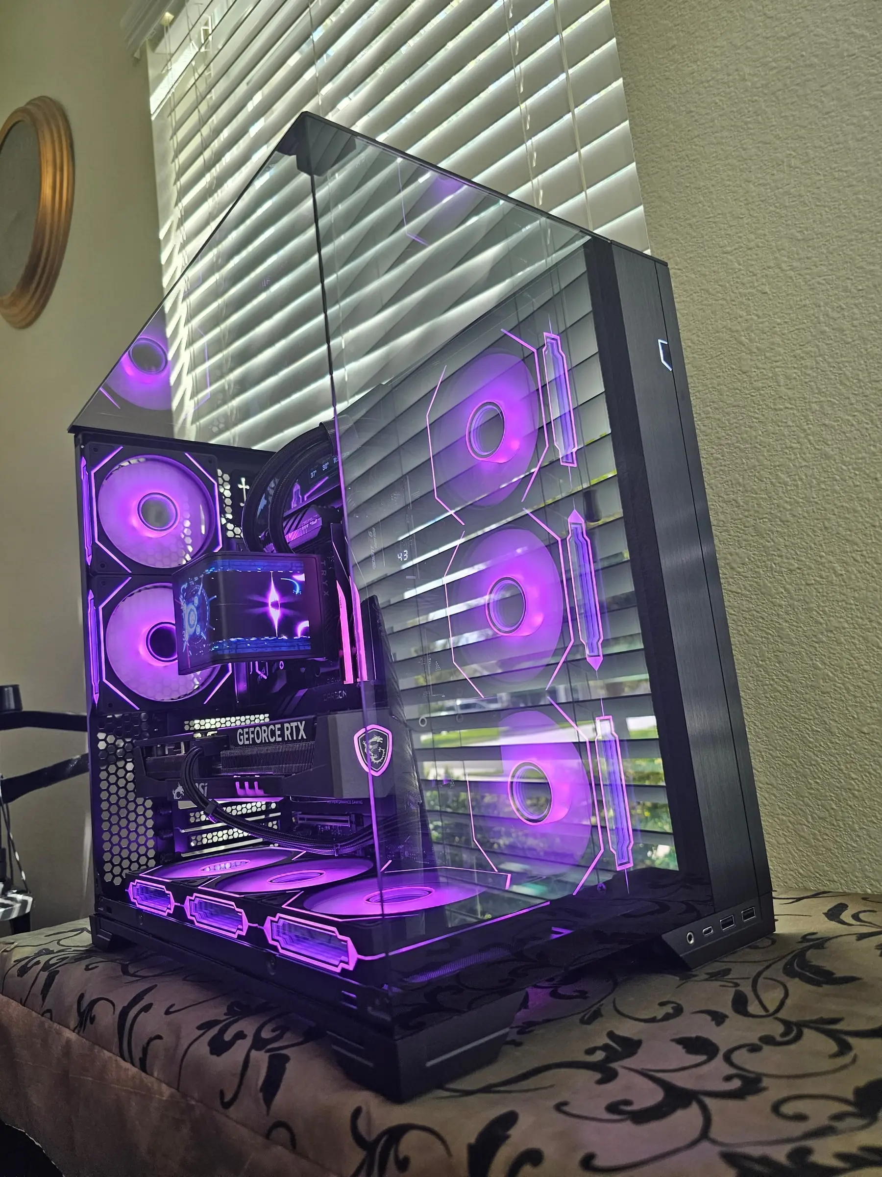 Purple theme — hex fan outlines glowing through the smoked glass, MSI shield lit on the Trio