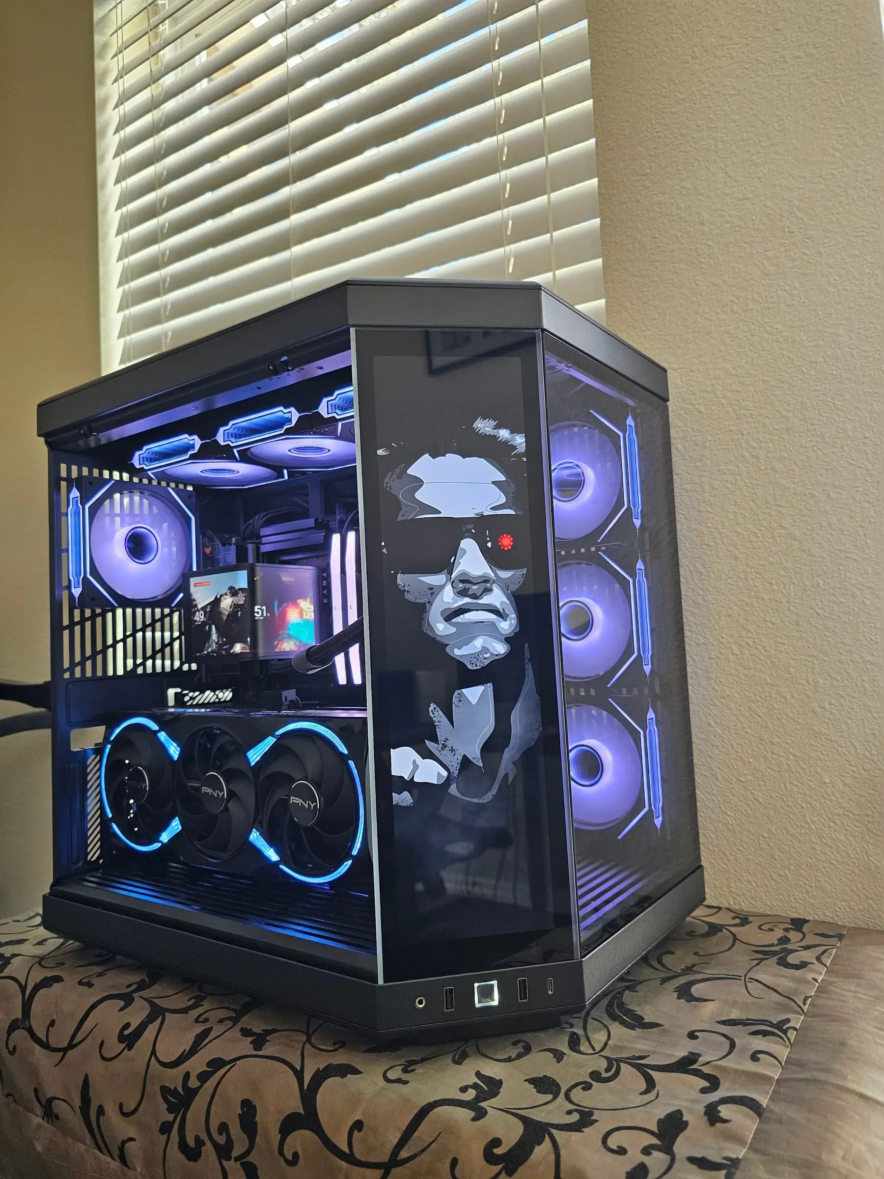 Blue theme — the PNY card's lit fan rings and the pump screen reading temps