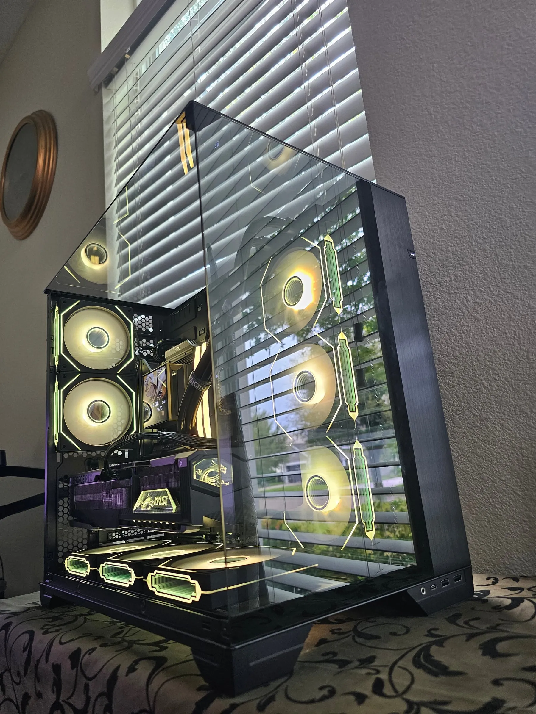 Lian Li O11 Vision in a gold-green theme, Hyper Vision LCD showing samurai art through the pillarless glass corner