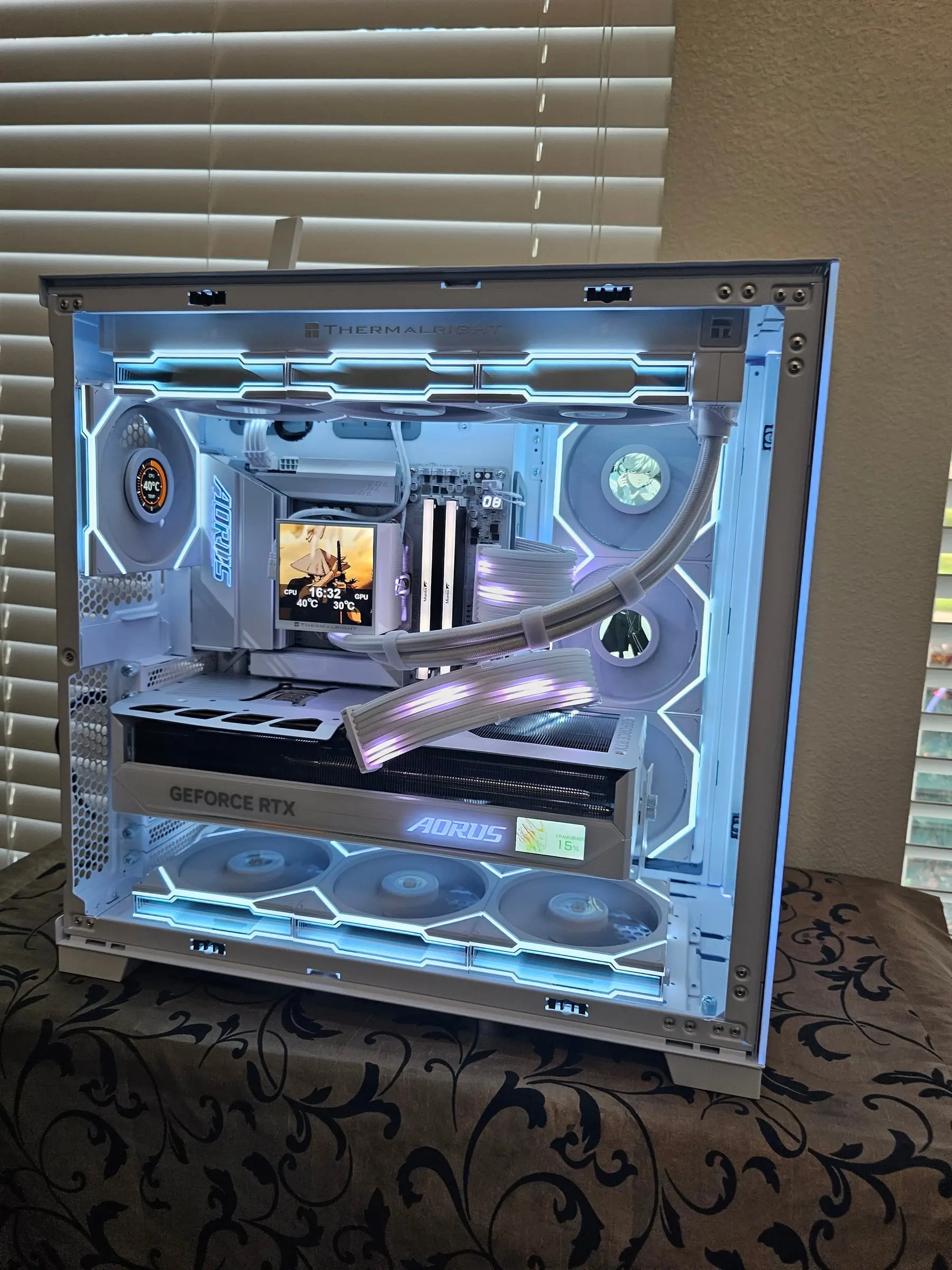 Straight-on view — the Master Ice's onboard display reading VRAM usage, KLEVV sticks and braided loop above