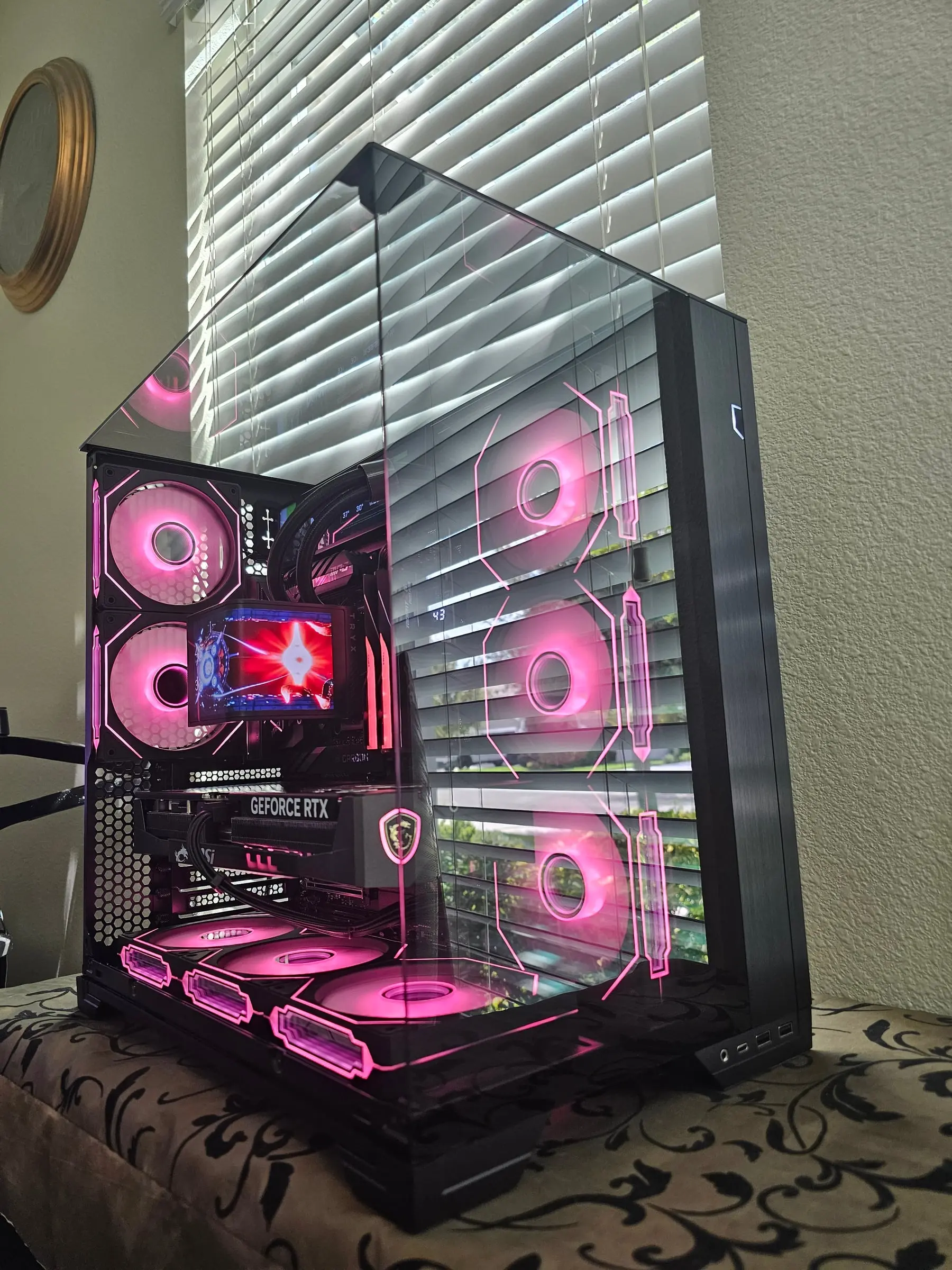 Hot pink theme across the fan walls with the AMOLED mid-animation