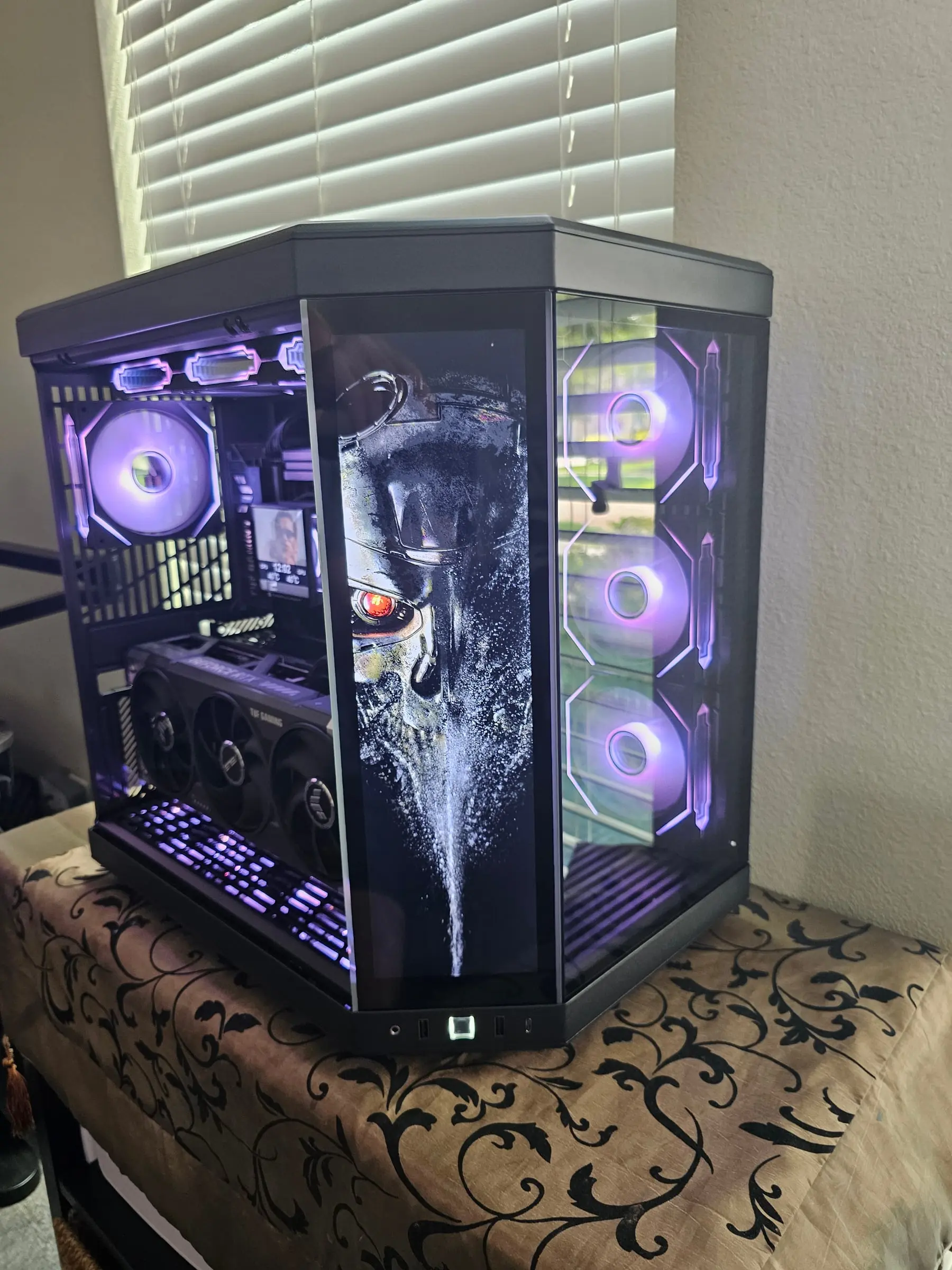 Terminator endoskeleton art with red eye on the front display, purple fans behind