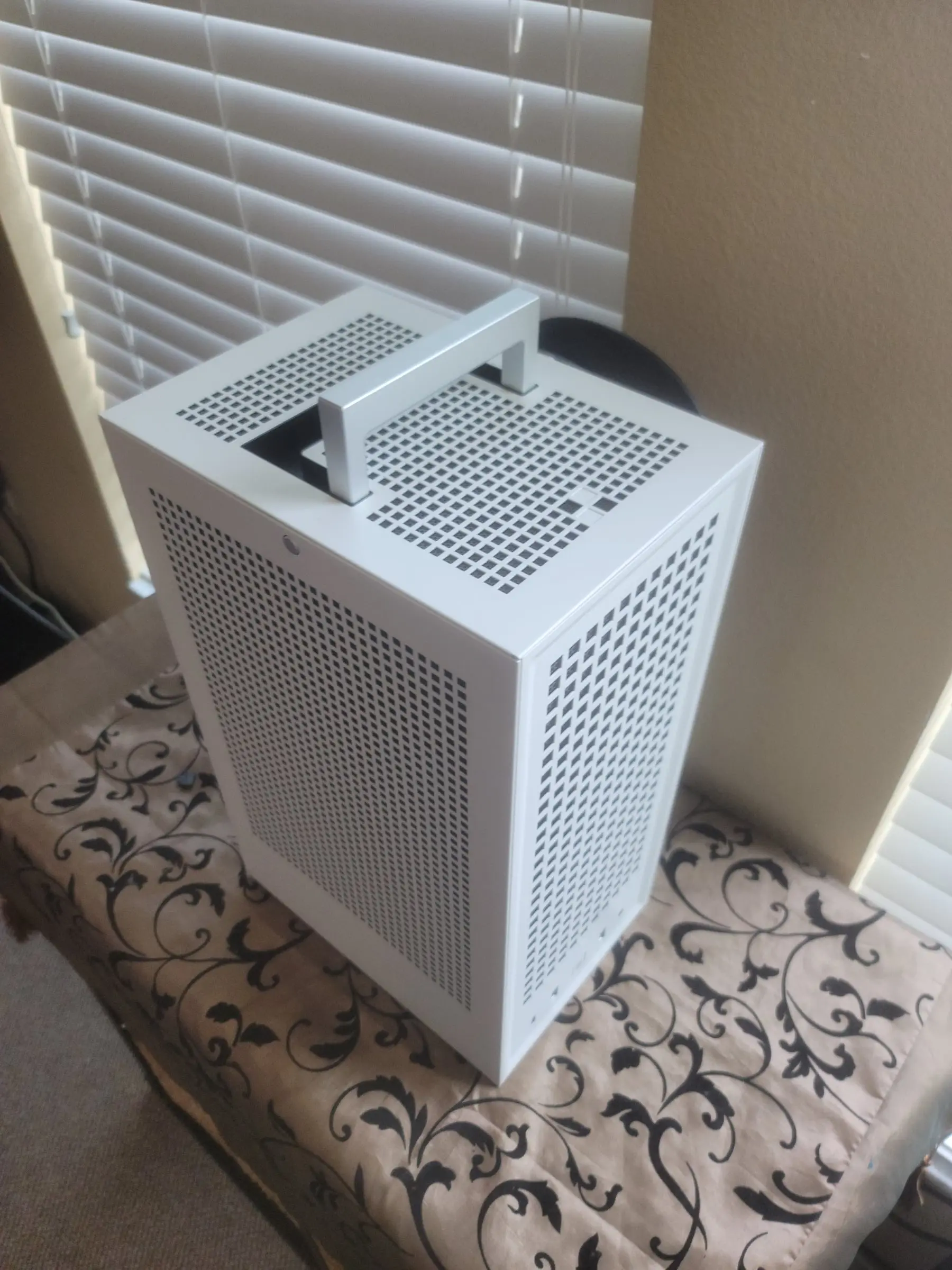 Top-down over the silver handle and vented roof of the ITX tower