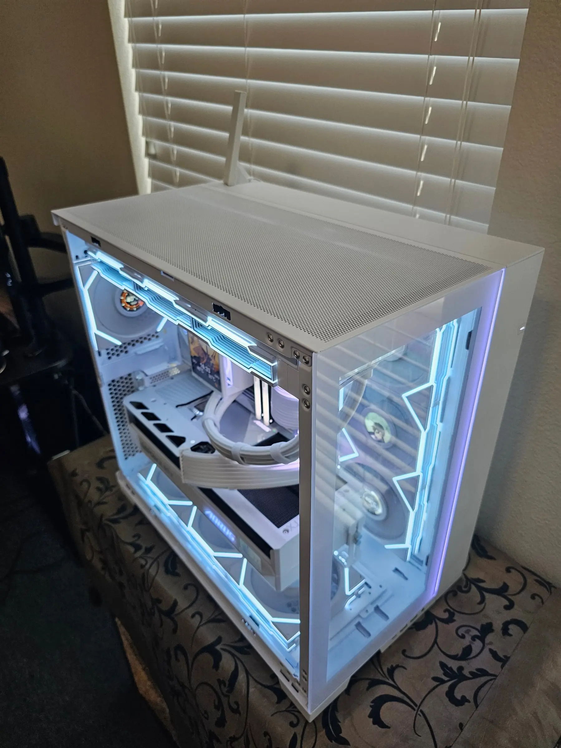 Top-down over the white chamber showing the GPU anti-sag bracket and rear fan screens