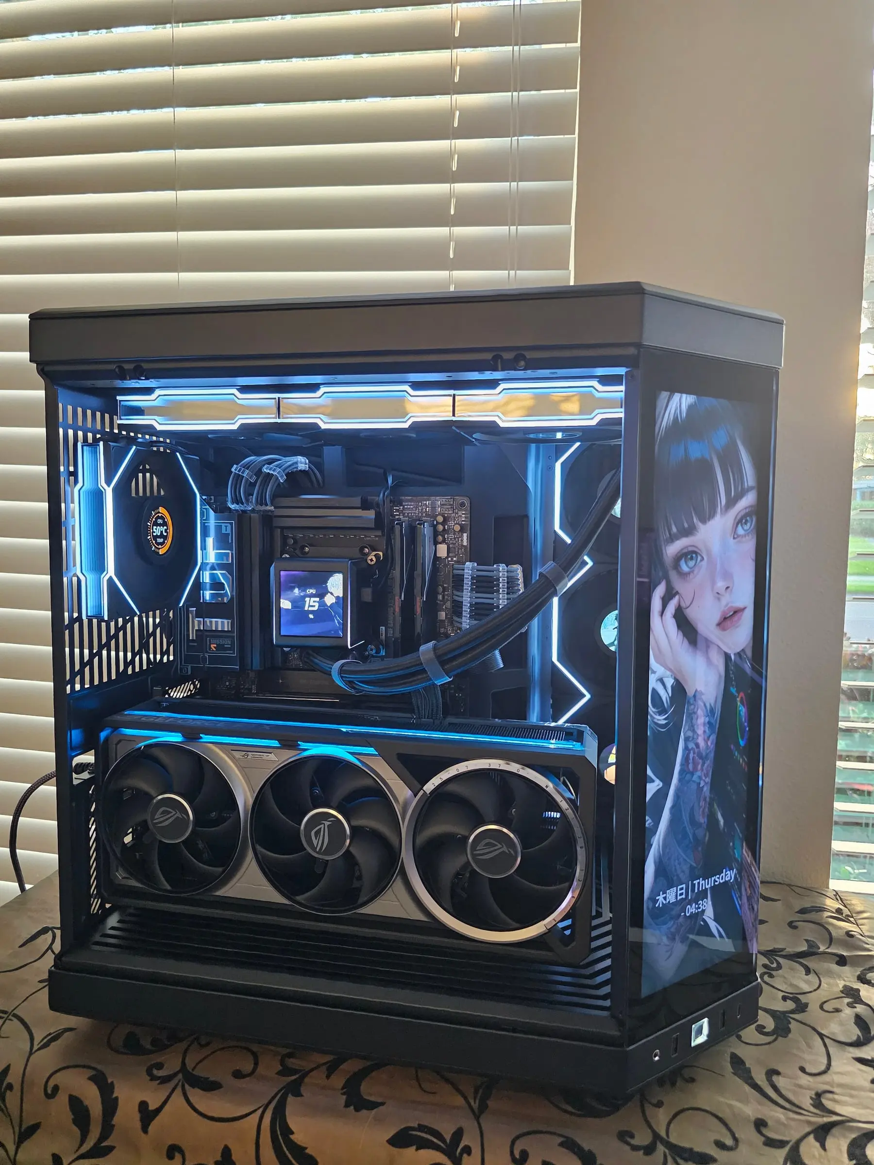 Open interior — TUF board, Galahad II pump LCD, braided cables, and the Astral RTX 5080