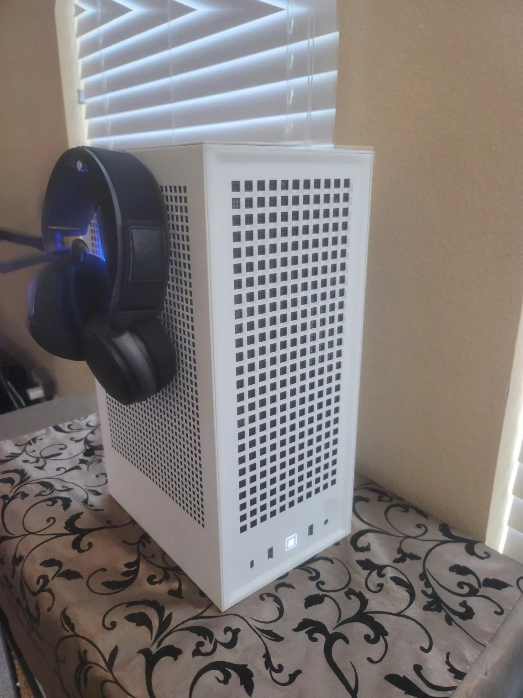 Headset hanging from the Revolt 3's pull-out hanger, power LED glowing