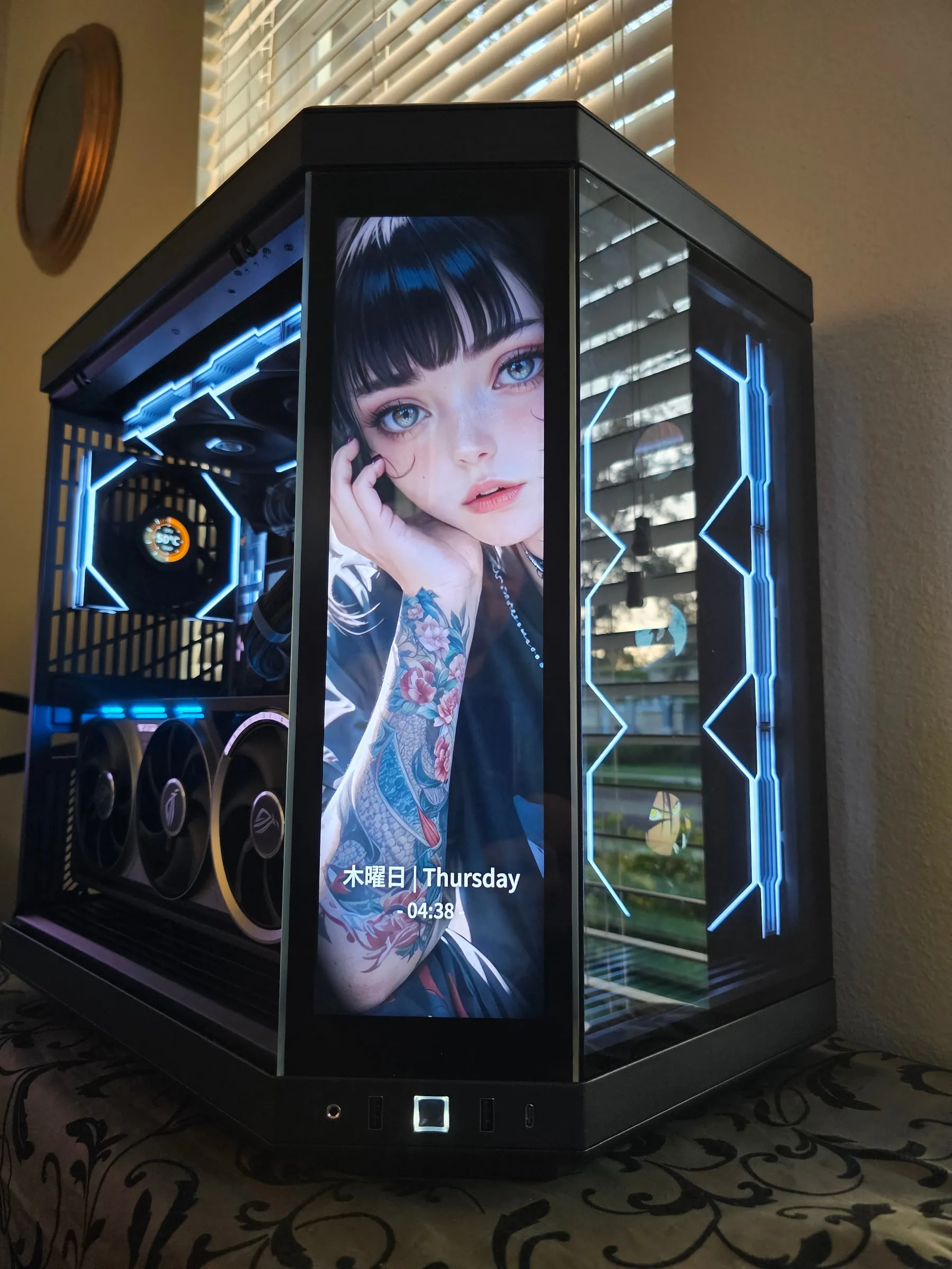 Y70 Touch in ice blue — tattooed anime portrait with a live Thursday clock on the front screen, hex fans glowing