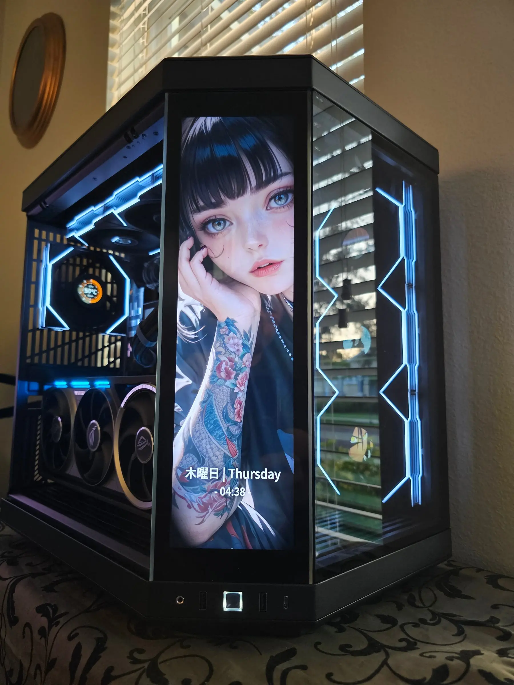 Y70 Touch in ice blue — tattooed anime portrait with a live Thursday clock on the front screen, hex fans glowing