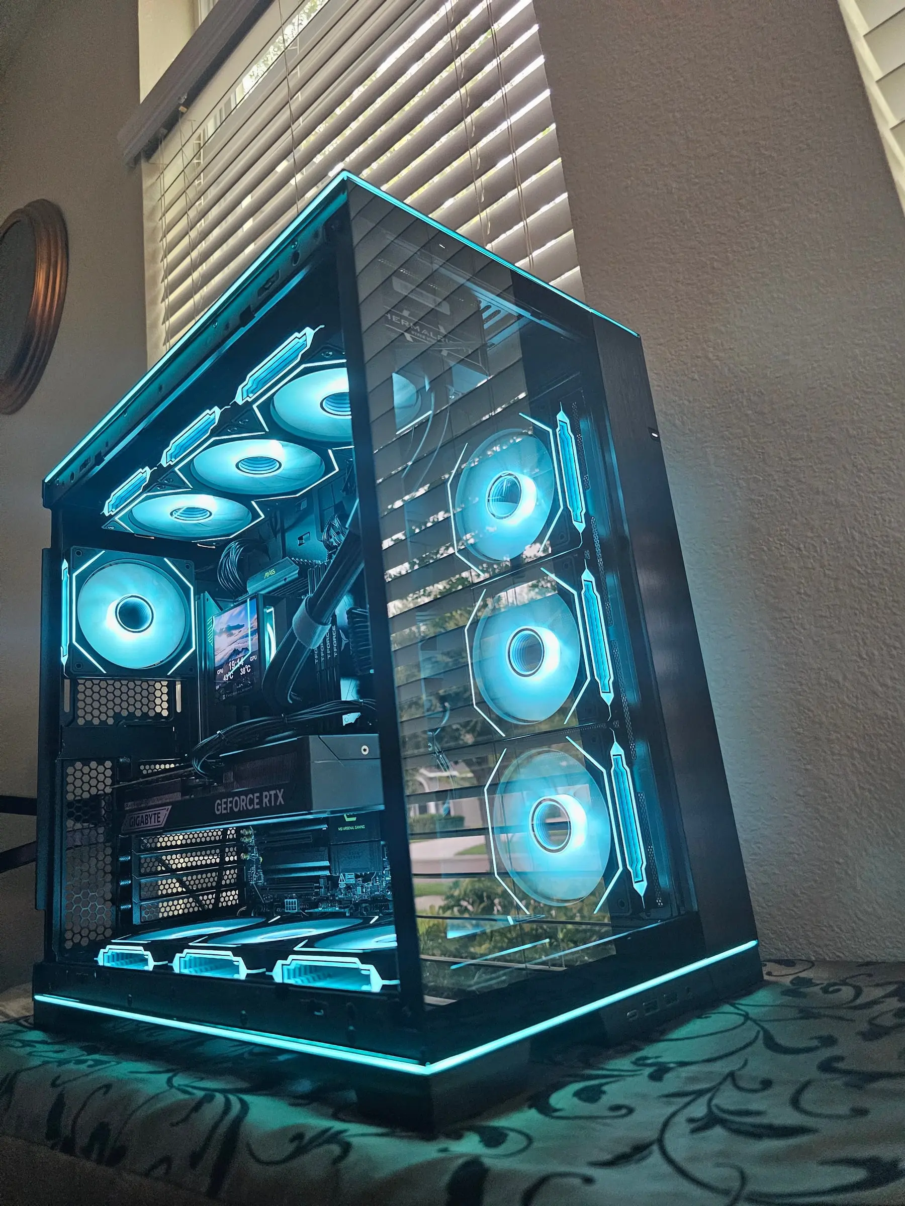 Cyan theme from the front corner, case edge strips glowing along every line
