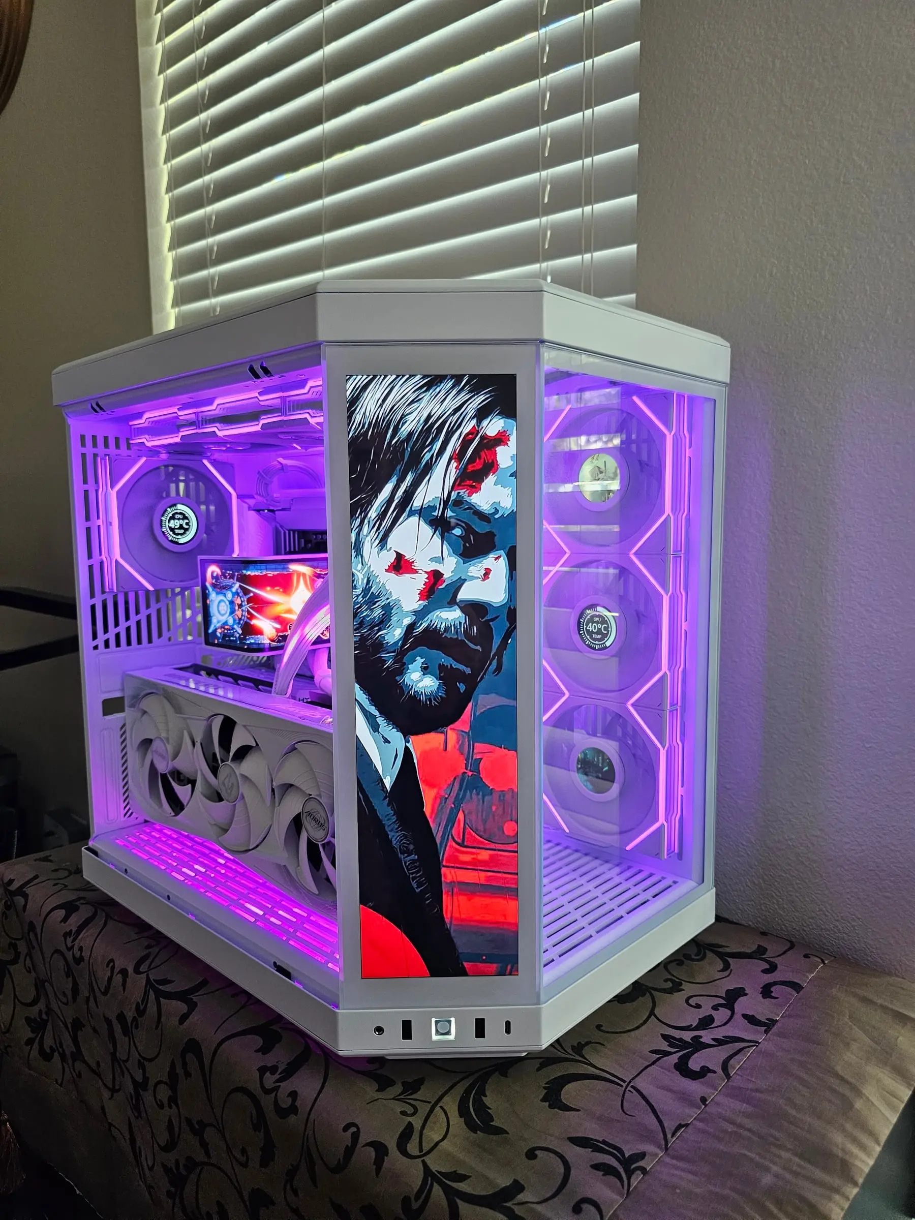 Purple-lit interior with a pop-art John Wick portrait on the touchscreen