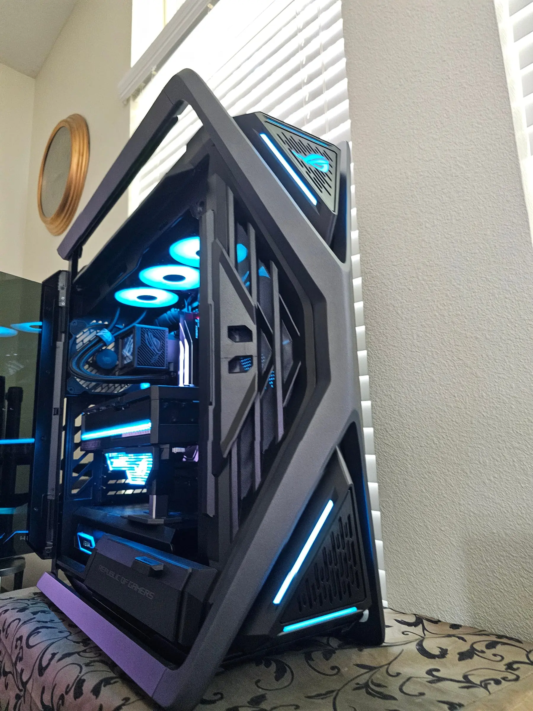 Cyan theme — Ryujin LCD and ROG logos lit teal through the hinged glass