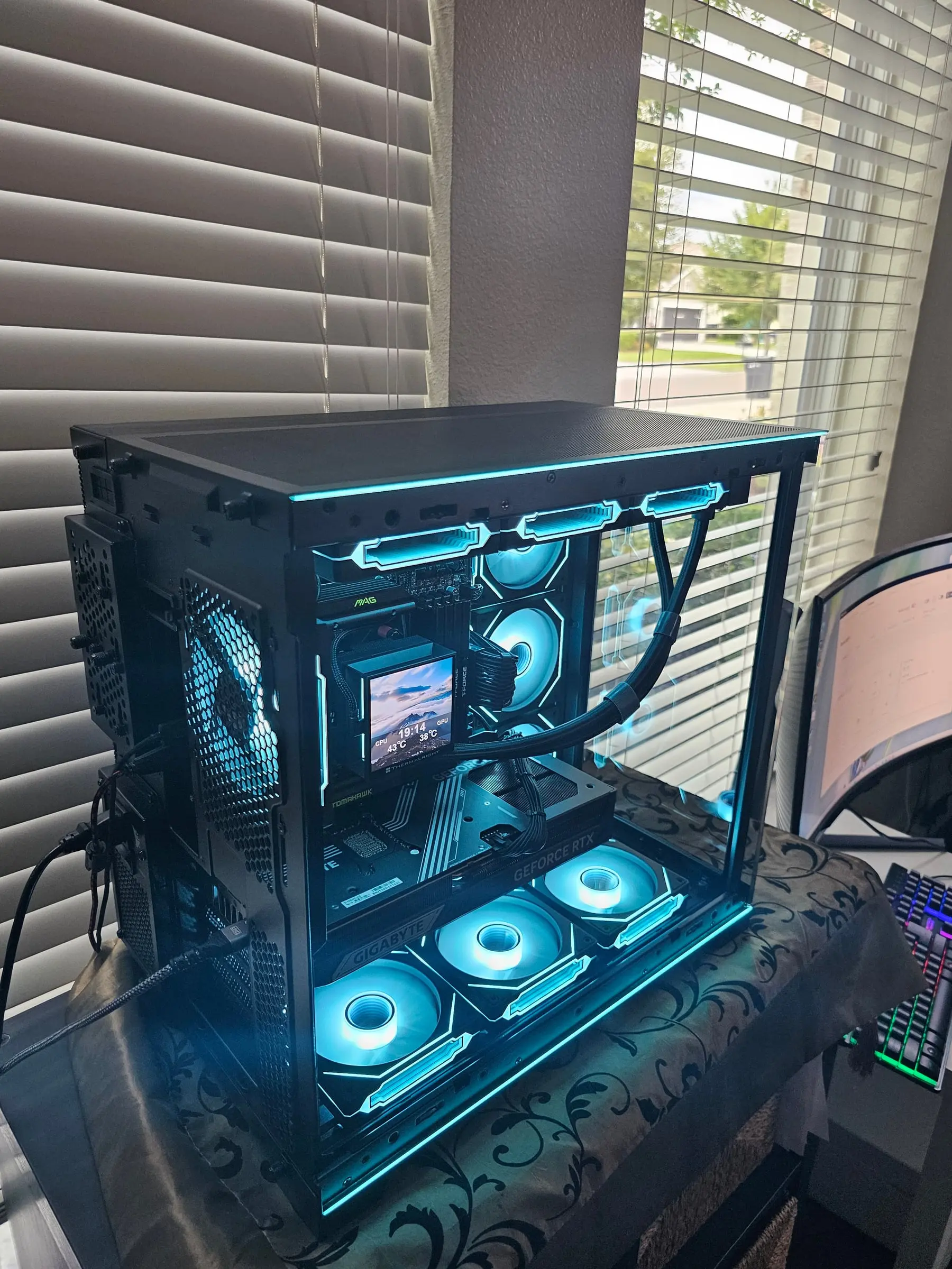Deep blue theme filling the glass box, GeForce RTX badge lit