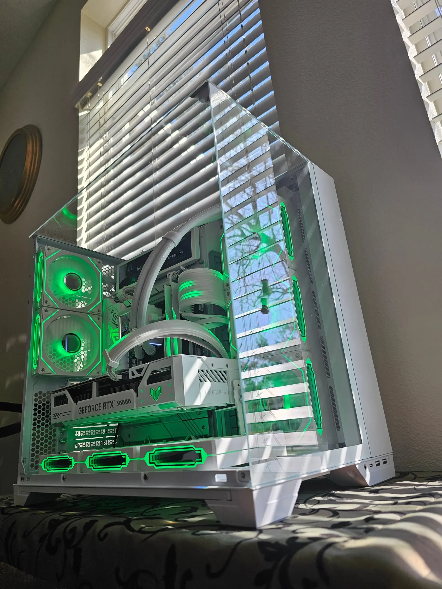 Emerald green flooding the white chamber, both displays running artwork
