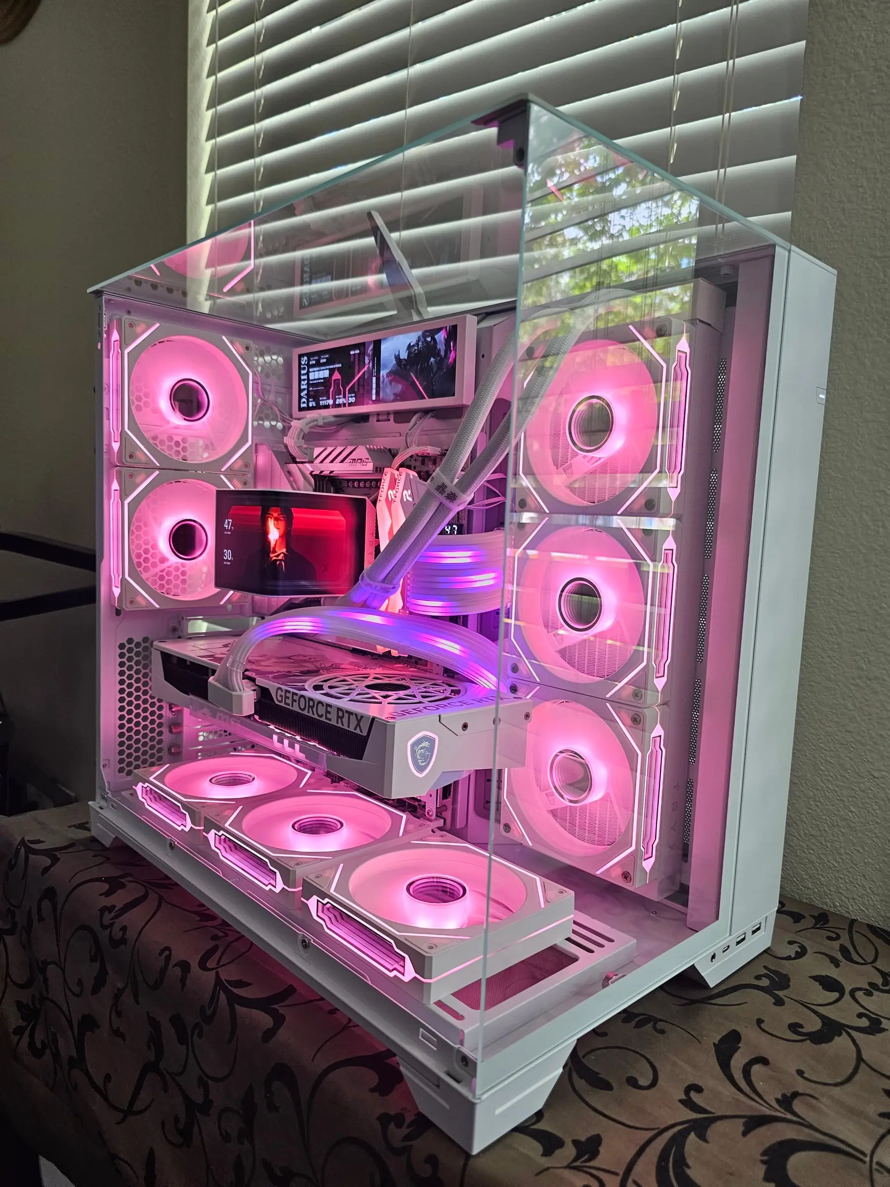 All-white O11 Vision in hot pink — Frieren Edition card's anime backplate, AMOLED running art, and eight glowing fans