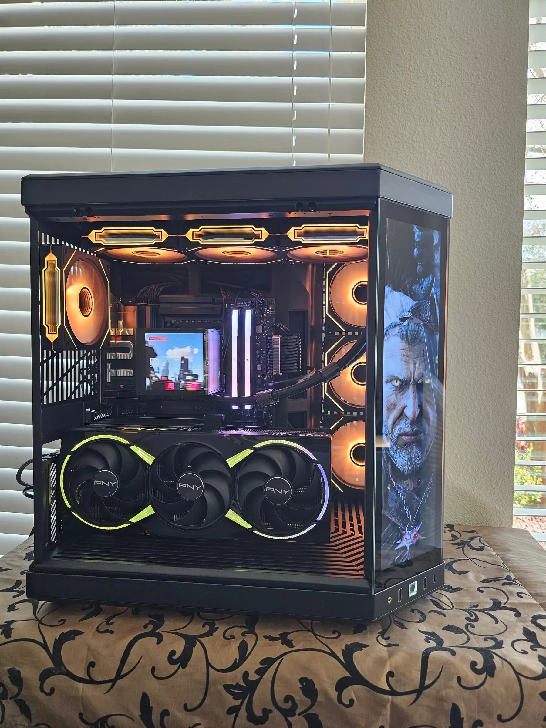 Witcher Geralt on the side display panel with amber fans and the AMOLED showing a cityscape
