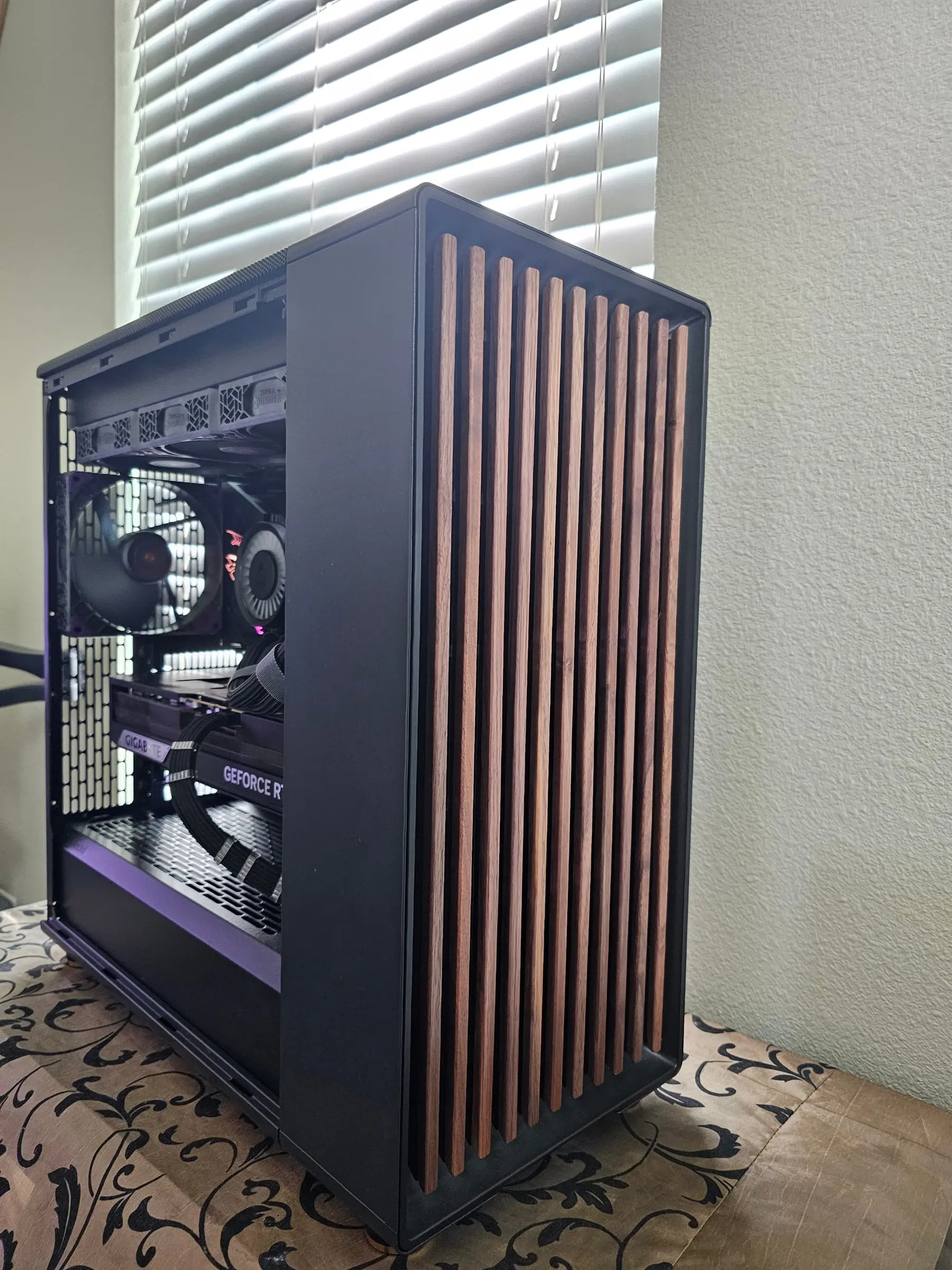 Walnut front and open interior showing the Gigabyte card and braided power runs