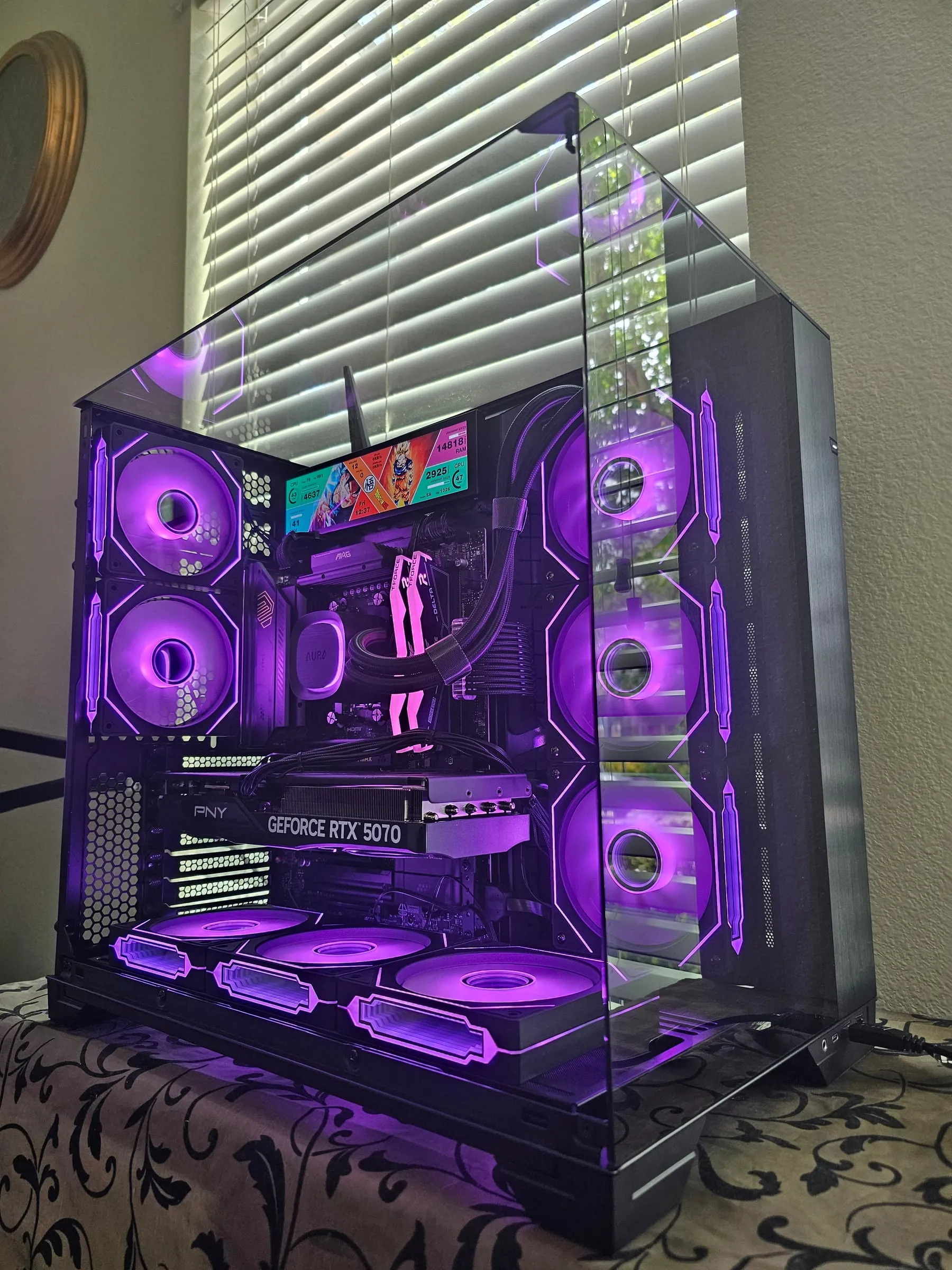 O11 Vision in deep purple with the 8.8-inch sensor panel showing Dragon Ball art and live system stats