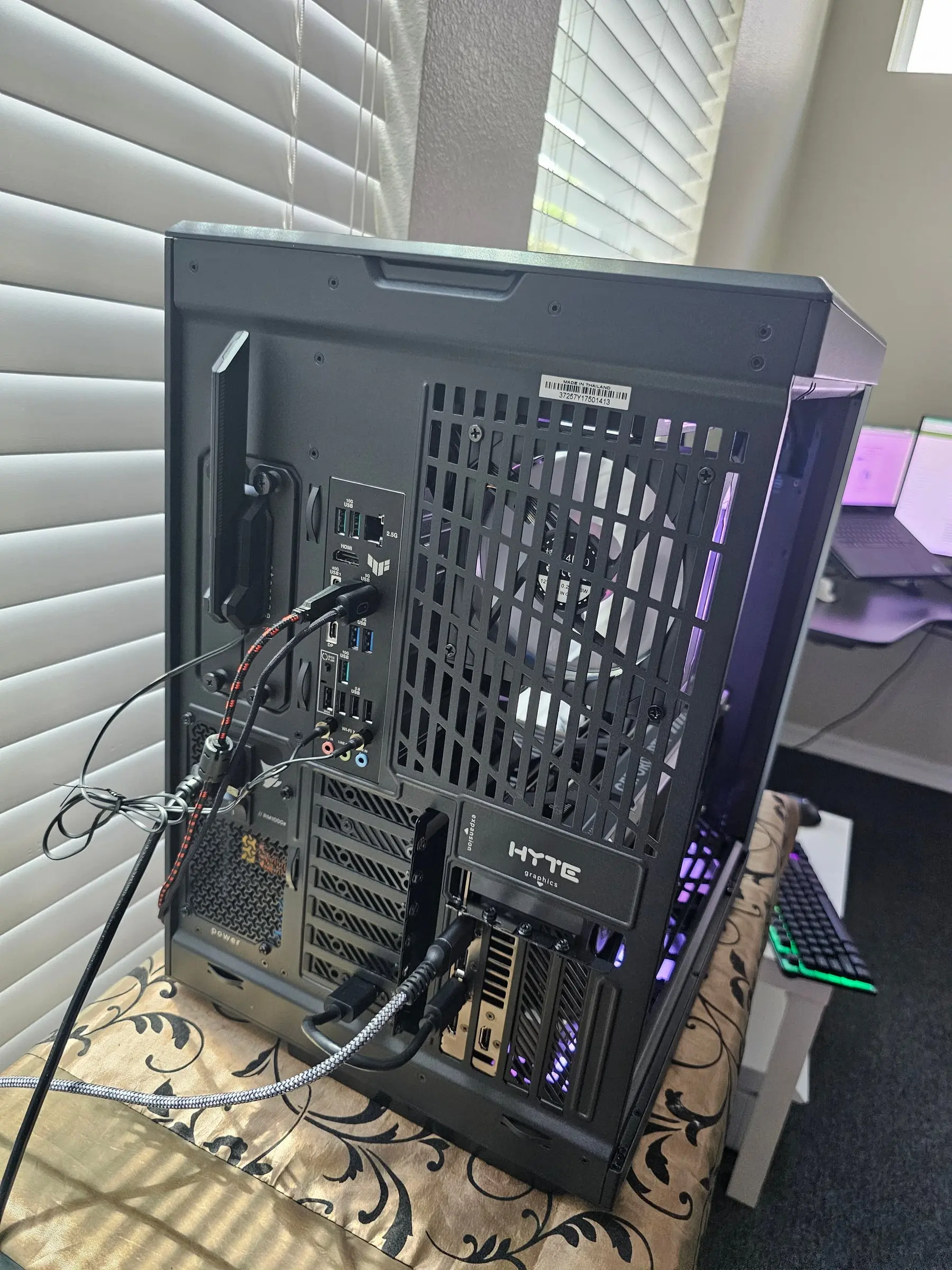 Rear I/O of the ROG Strix X870E-E with the modular PSU and Hyte expansion bracket