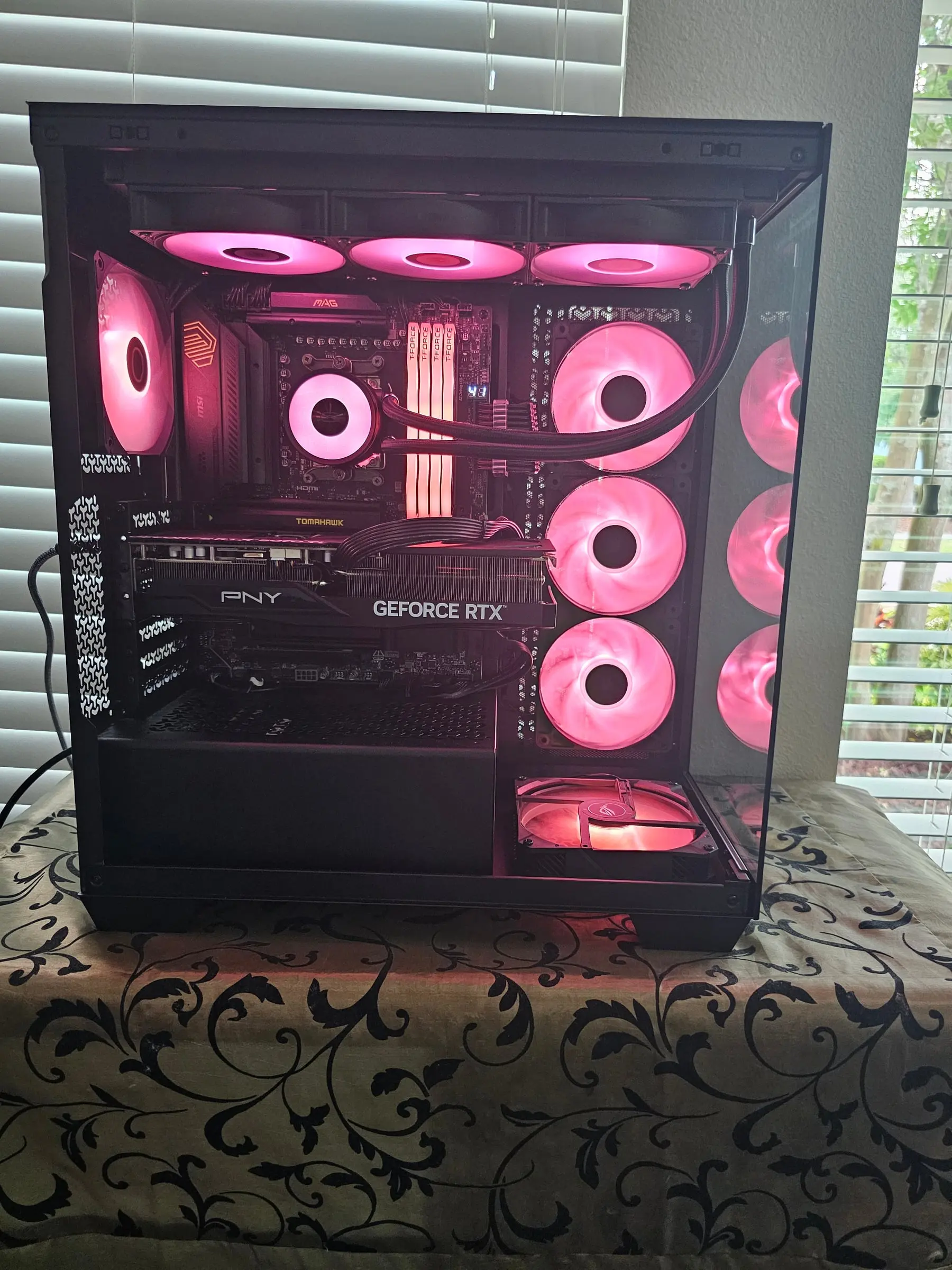 Hot pink theme filling the chamber — top radiator fans, side wall, and bottom intake all synced