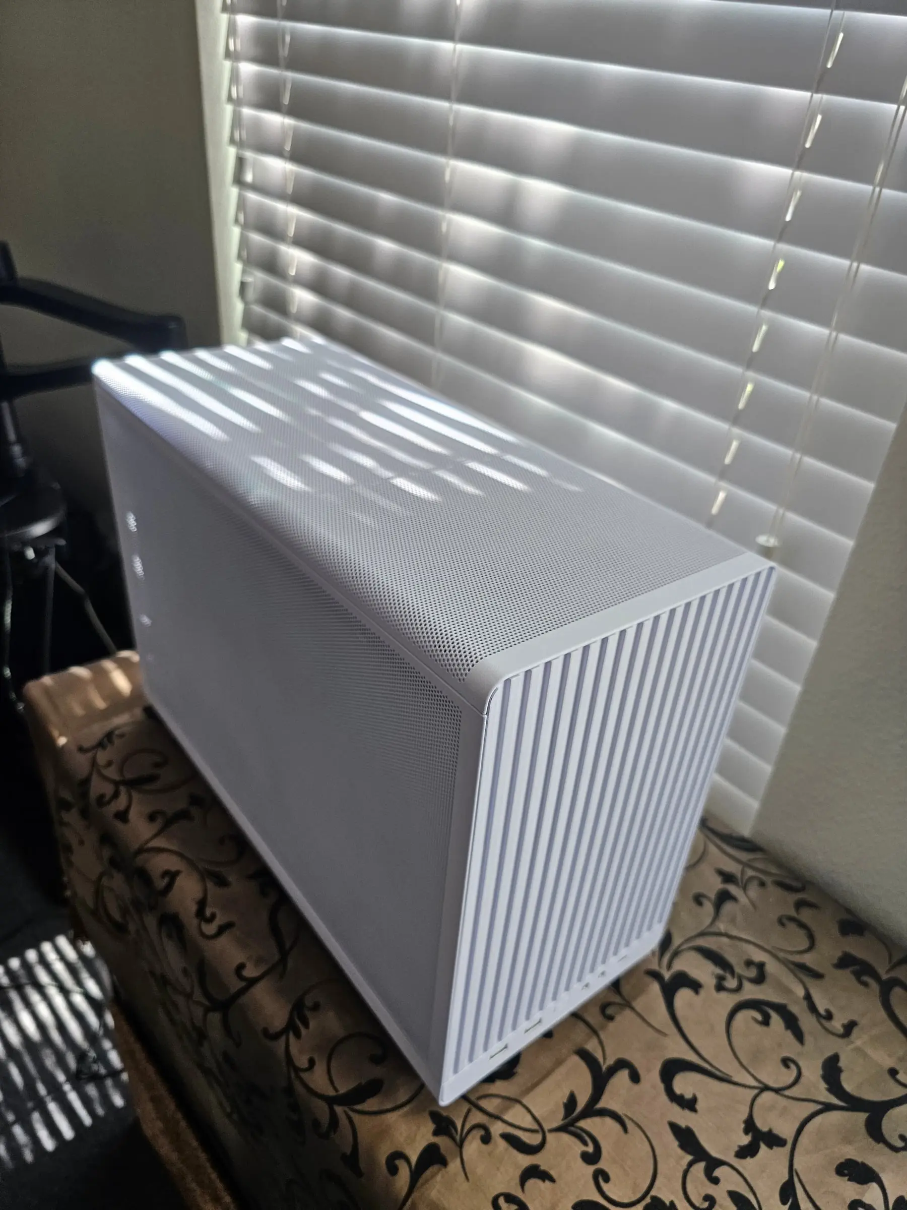 High angle over the top panel and perforated side of the Lian Li A3 White