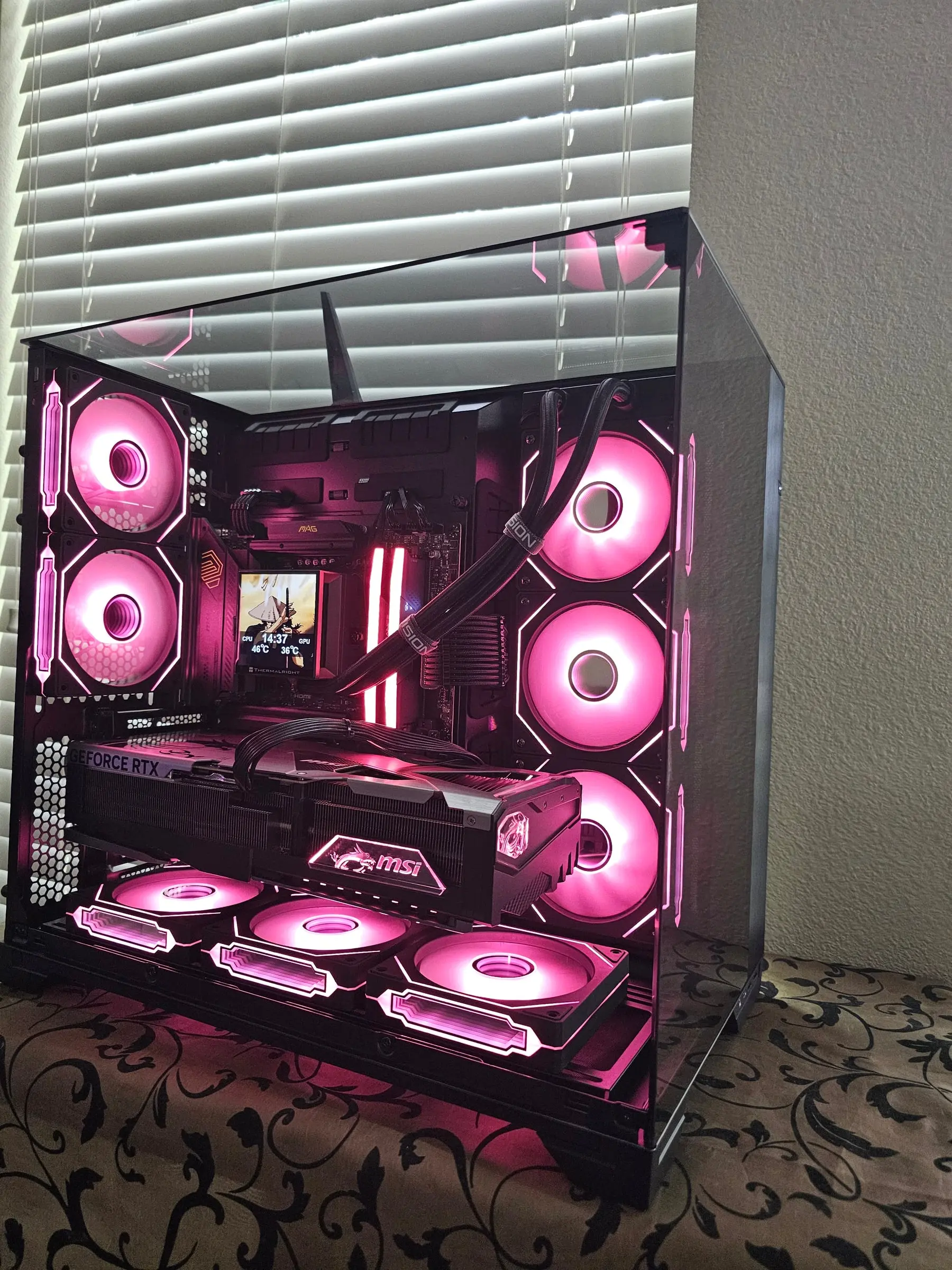 Magenta theme across all eight Prism fans with the MSI Vanguard front and center