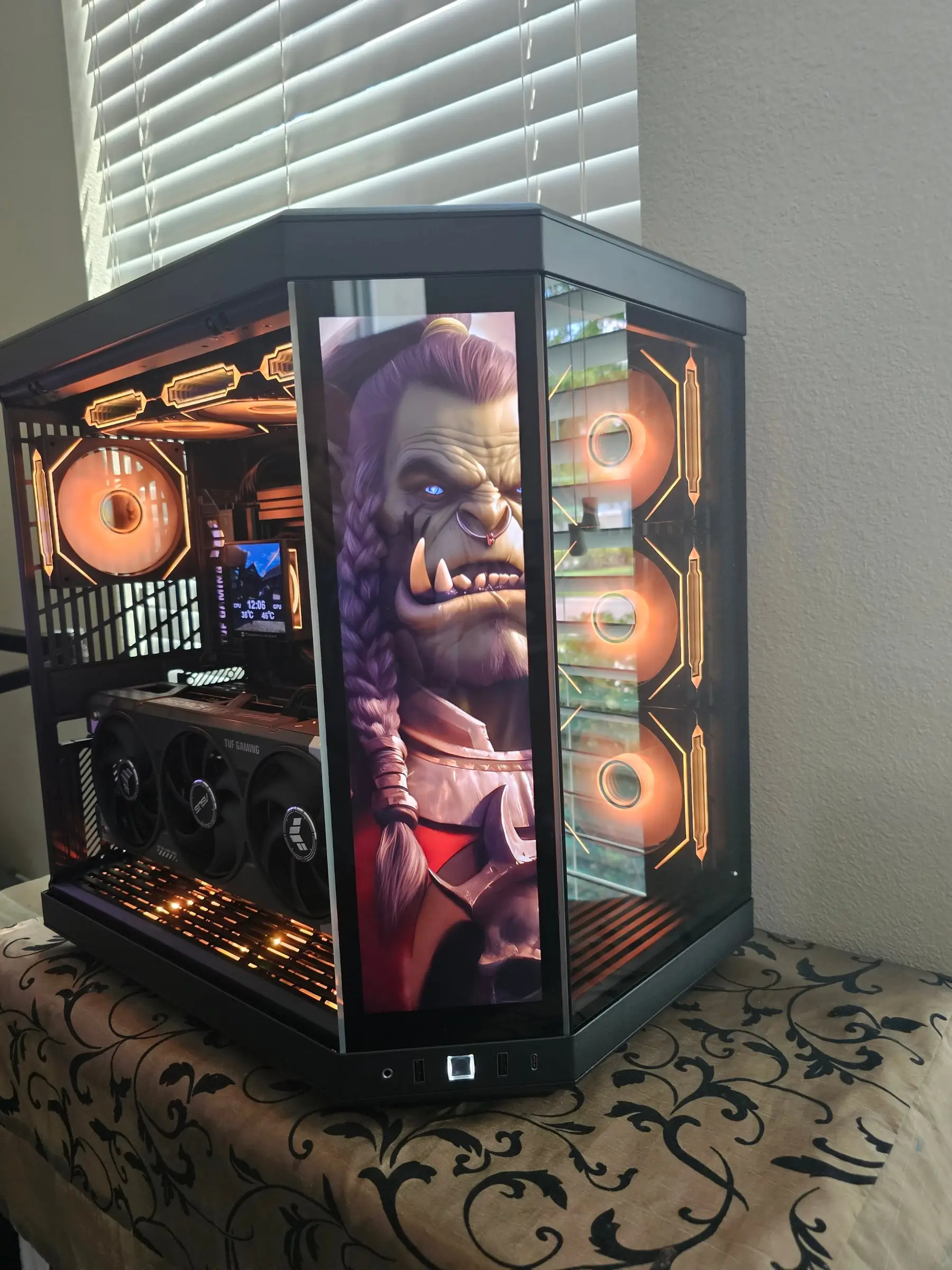 Orange theme with a World of Warcraft orc portrait on the front display